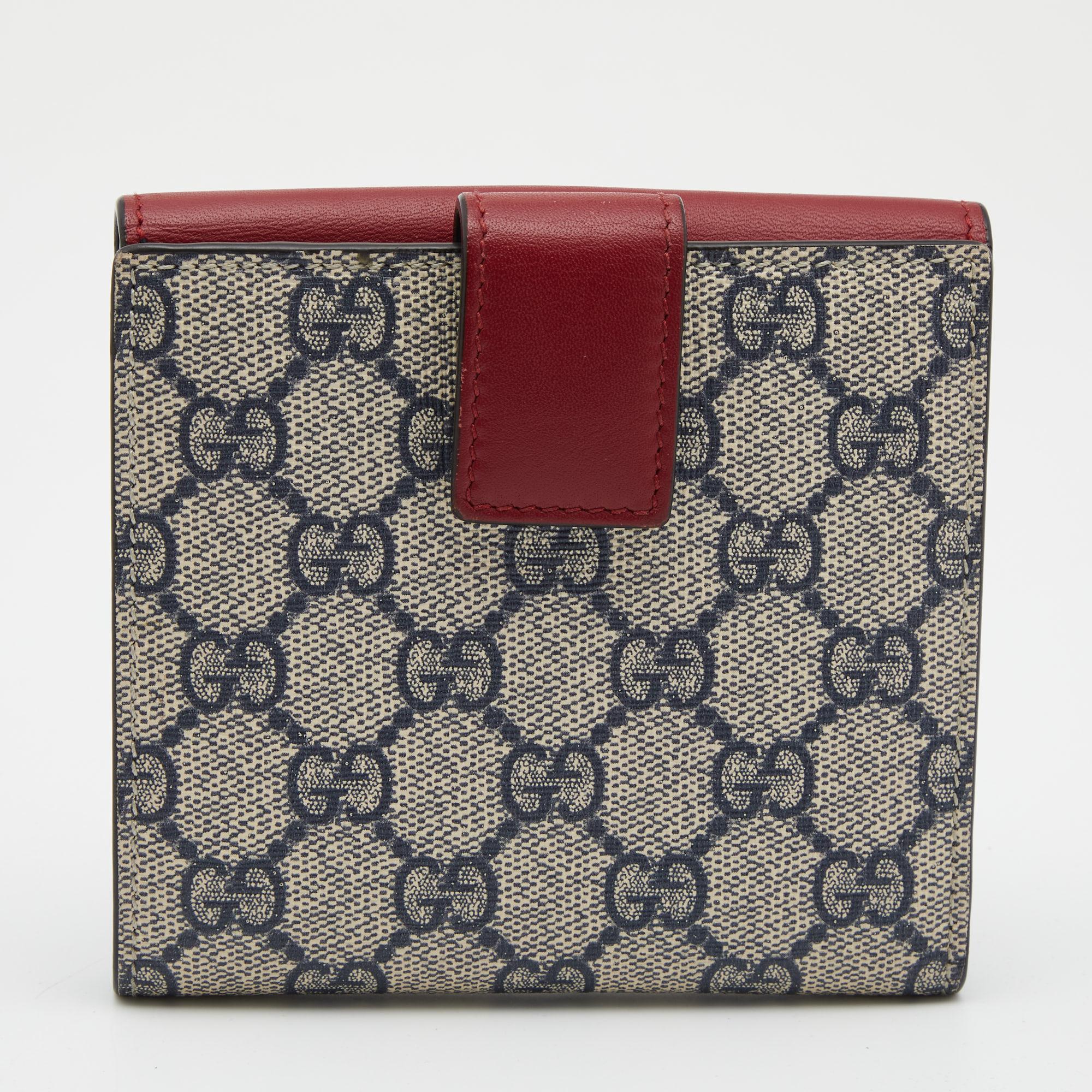 Bringing a blend of remarkable fashion and fine craftsmanship is this wallet from Gucci. The red and blue wallet comes crafted from GG Supreme canvas and is styled with leather trims as well as a Web bow detail on the front. It has a smooth interior