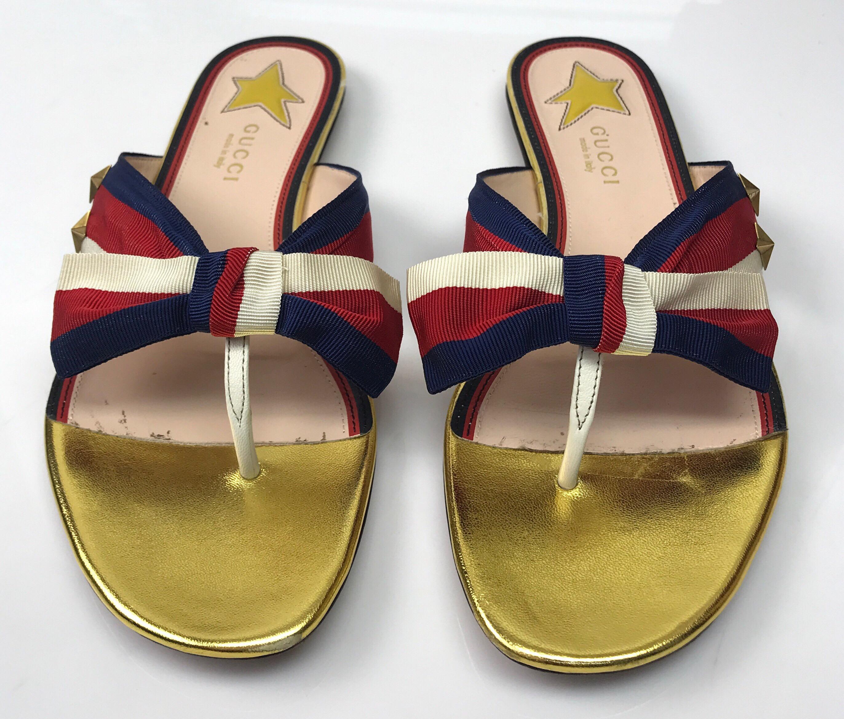 Gucci Red, Blue, & Ivory Thong Sandal-38. These adorable Gucci sandals are in great condition. They show slight use to the bottom of the shoe and small markings on the base of the show, as shown in pictures. These sandals have a red, blue, and ivory