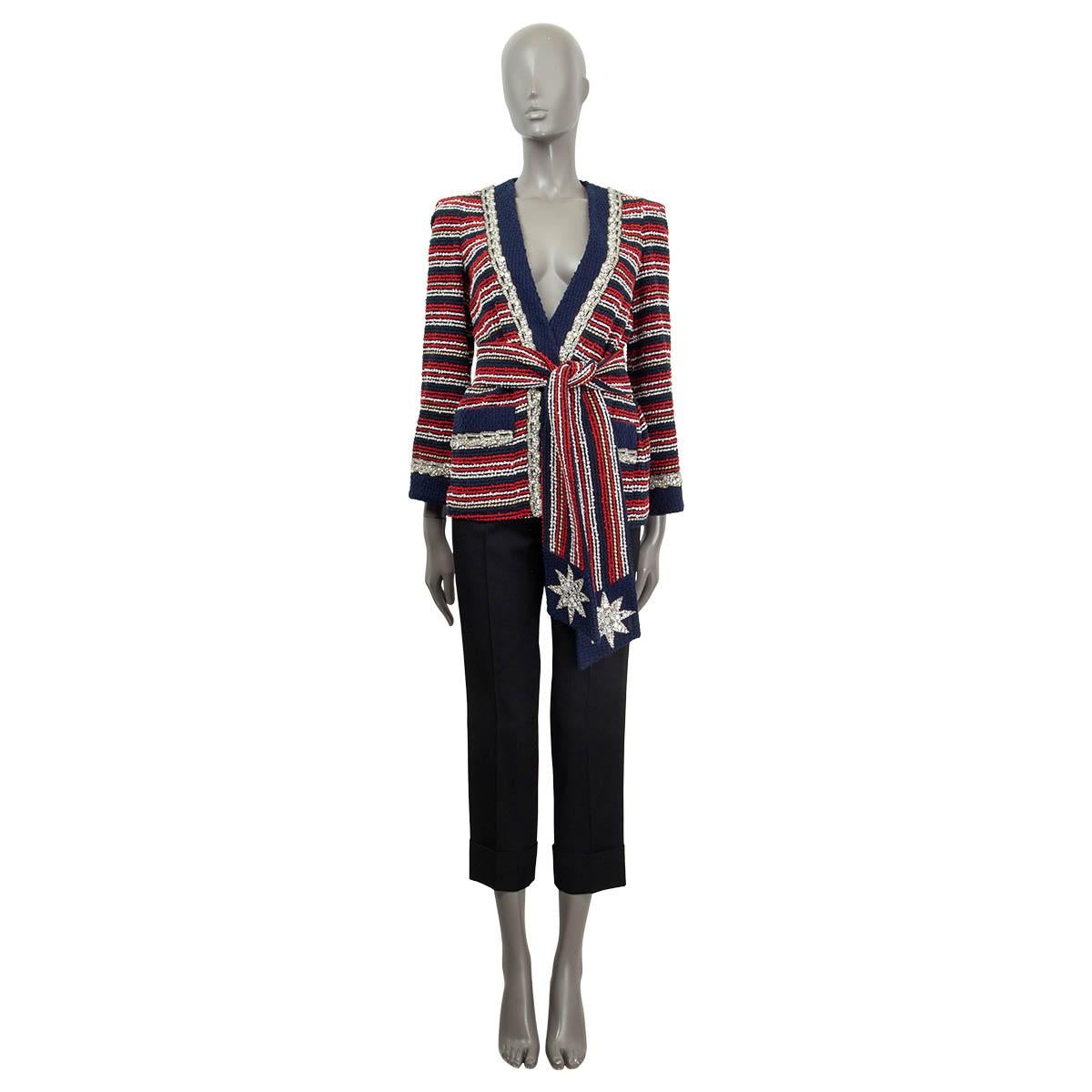 100% authentic Gucci  belted marine stripe bouclé jacket in navy, red, gold and white cotton (88%) and polyamide (12%). Lined in navy blue viscose (100%). The jacket closes with a crystal star embellished belt and two hidden hooks. It features two