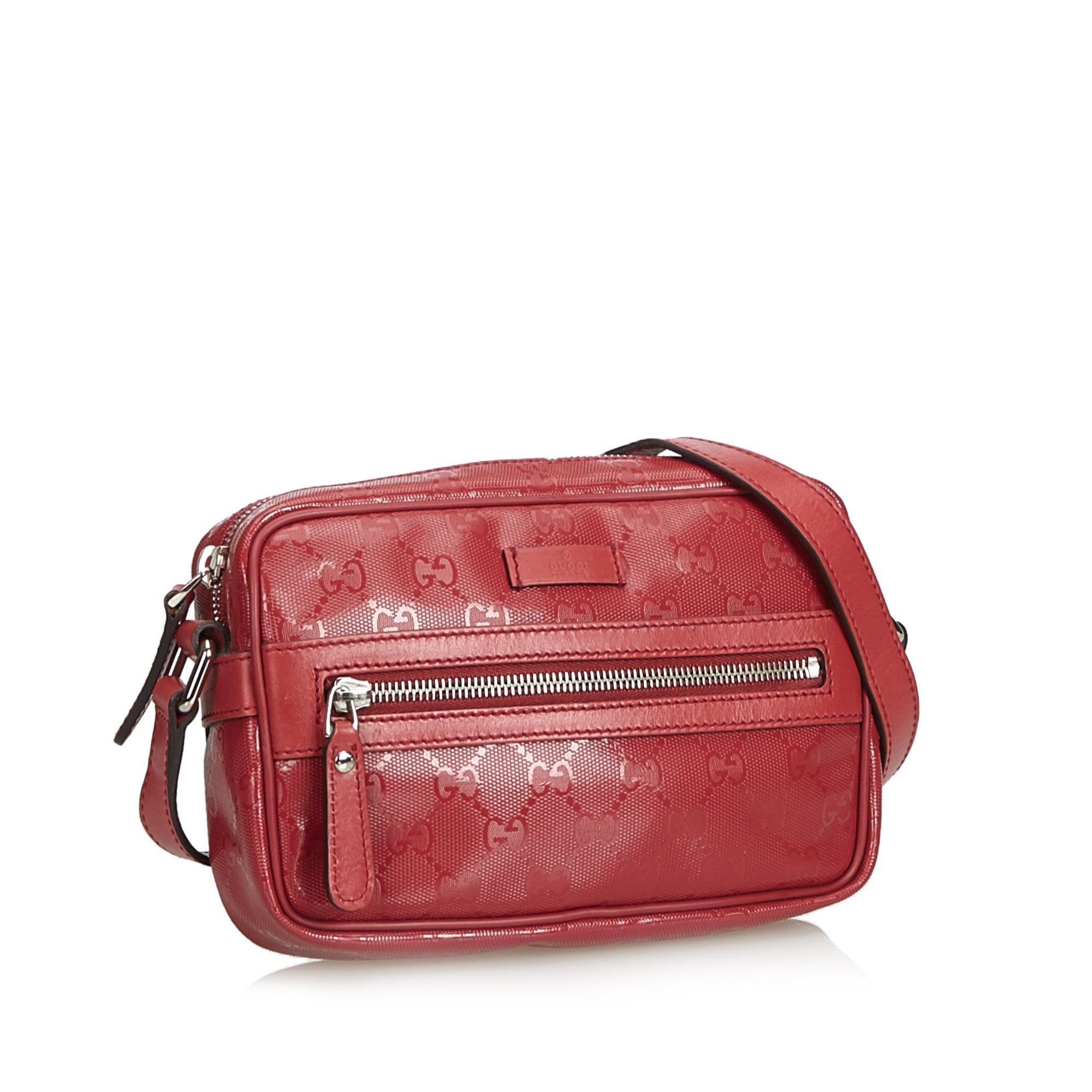 This crossbody bag features a pvc body with leather trim, flat leather strap, top zip closure, exterior zip pocket, and an interior zip pocket. It carries as AB condition rating.

Inclusions: 
This item does not come with