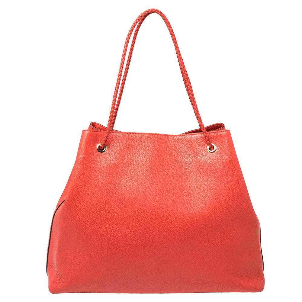 This tote by Gucci is an ideal option for keeping your daily essentials safe. Designed in a red shade, this leather tote will look fabulous with any outfit.. It is complete with braided handles and a spacious interior.

