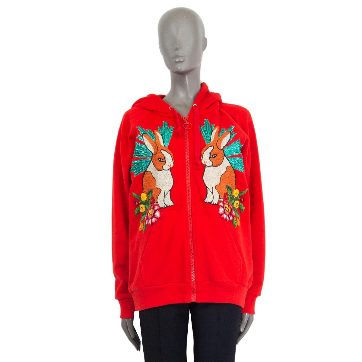 Gucci embroidered hoodie in red cotton (100%) with front pockets and long raglan sleeves. Has two rabbit embroidery details in orange, cream, grey, metallic green, yellow, pink, red and black cotton, nylon, polyethylene, polyester and silk. Closes