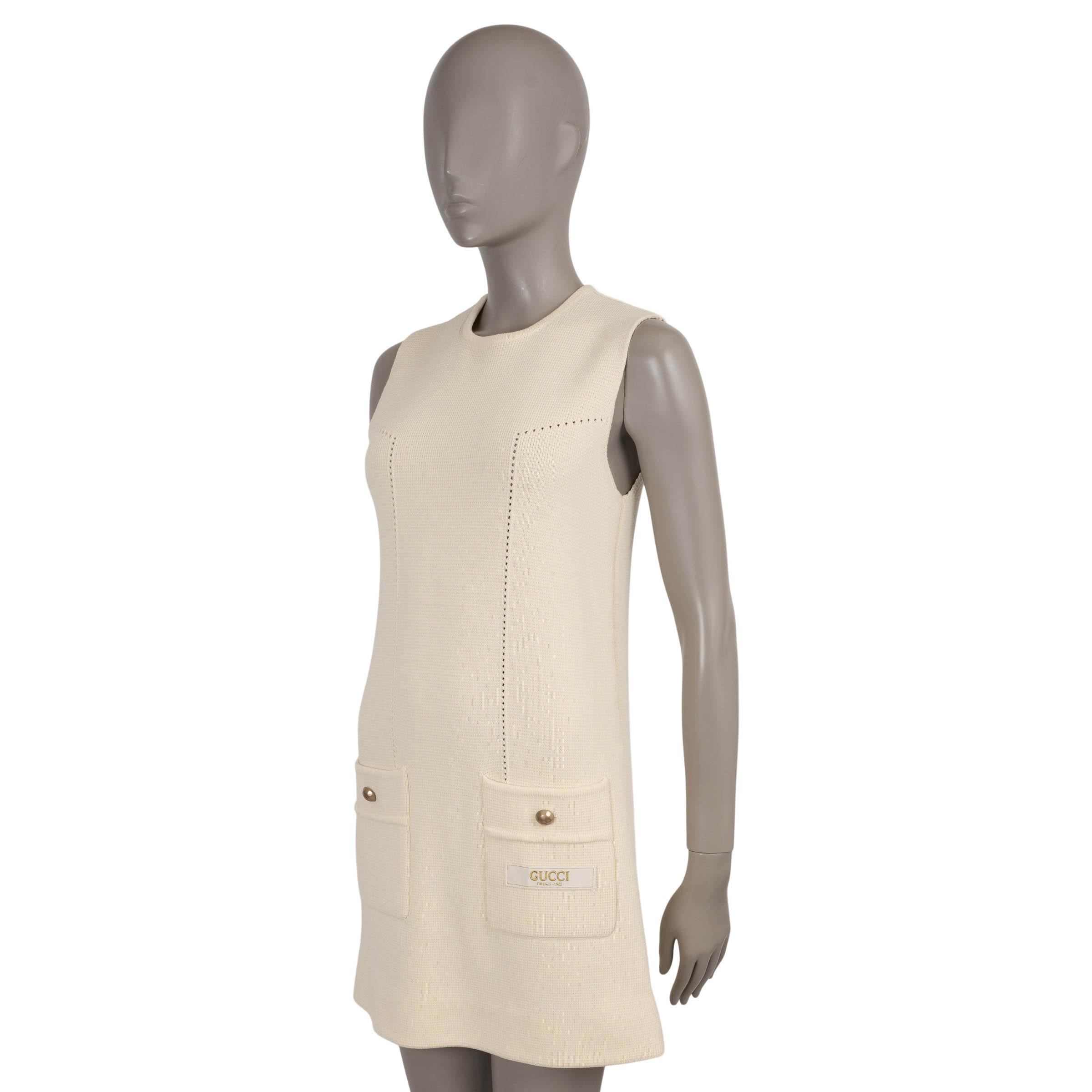 This 100% authentic Gucci dress is crafted in cream wool (100%) with refined pointelle detailing along the front seams. Designed with a sleeveless, slightly flared silhouette and mini length, it channels a distinctly retro sensibility. The look is