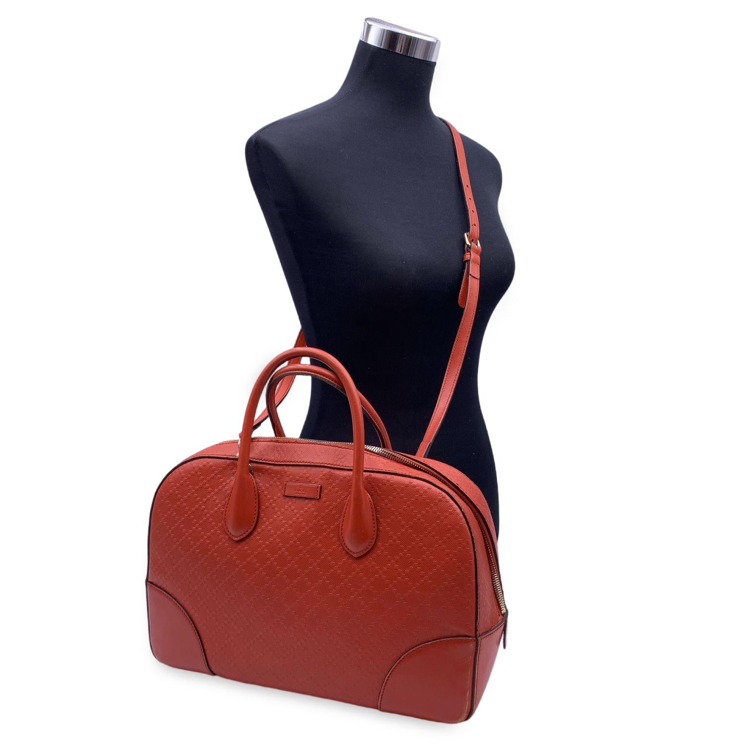 Beautiful Gucci 'Diamante Bright' in red orange leather. Embossed signature Gucci Diamante pattern. Silver metal hardware Double top handles and adjustable and removable shoulder strap. Upper zipper closure. Beige fabric lining. 2 side zip pockets