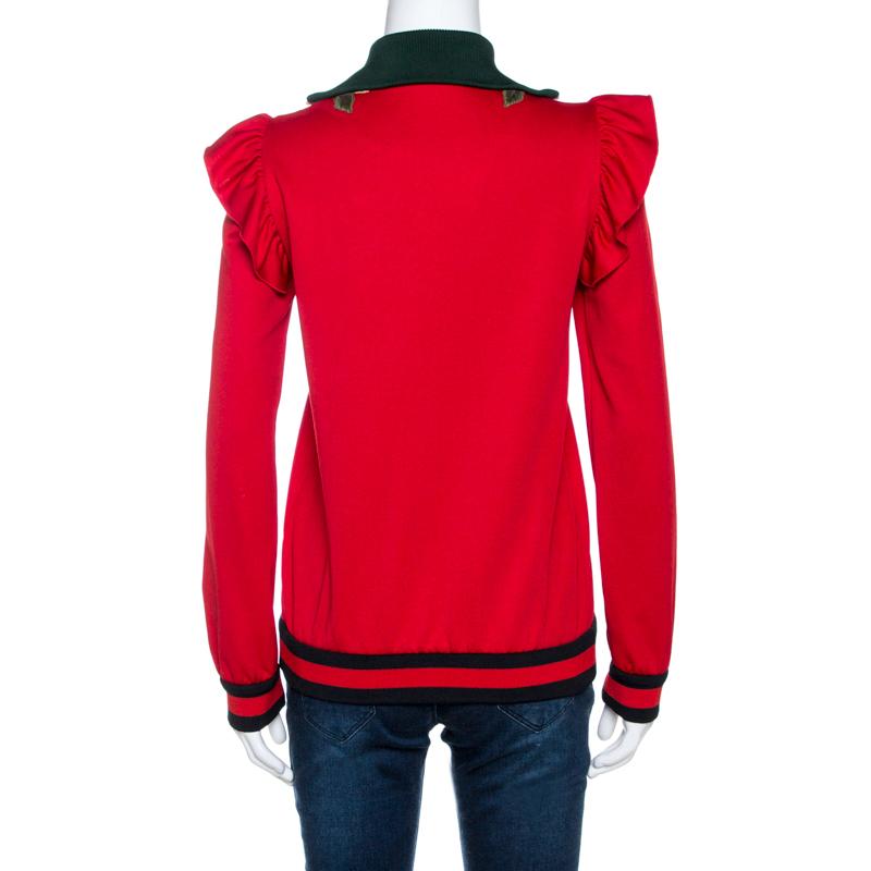 In more ways than one, this red jacket from Gucci is an incredible piece of luxury. It has a comfortable shape, great tailoring signs and a luxurious design. Cut from quality fabrics, the jacket features a front zipper, ruffle details, floral