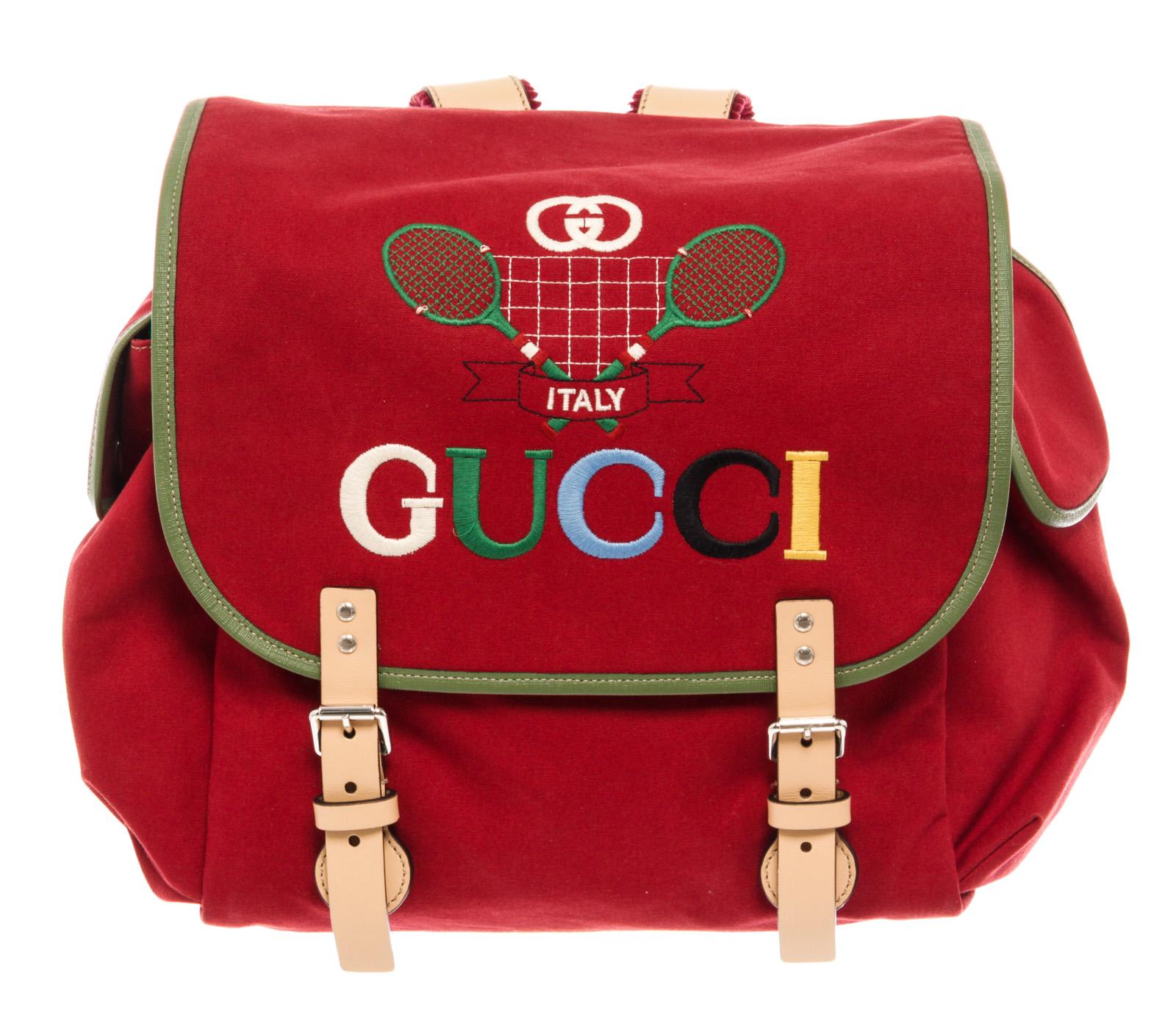 Red GG embroidered canvas Gucci Children's Tennis backpack with silver-tone hardware, tan leather trim, dual adjustable backpack straps, fold over top with magnetic closure, two side pockets and red canvas lining with slip pocket inside.



44979MSC