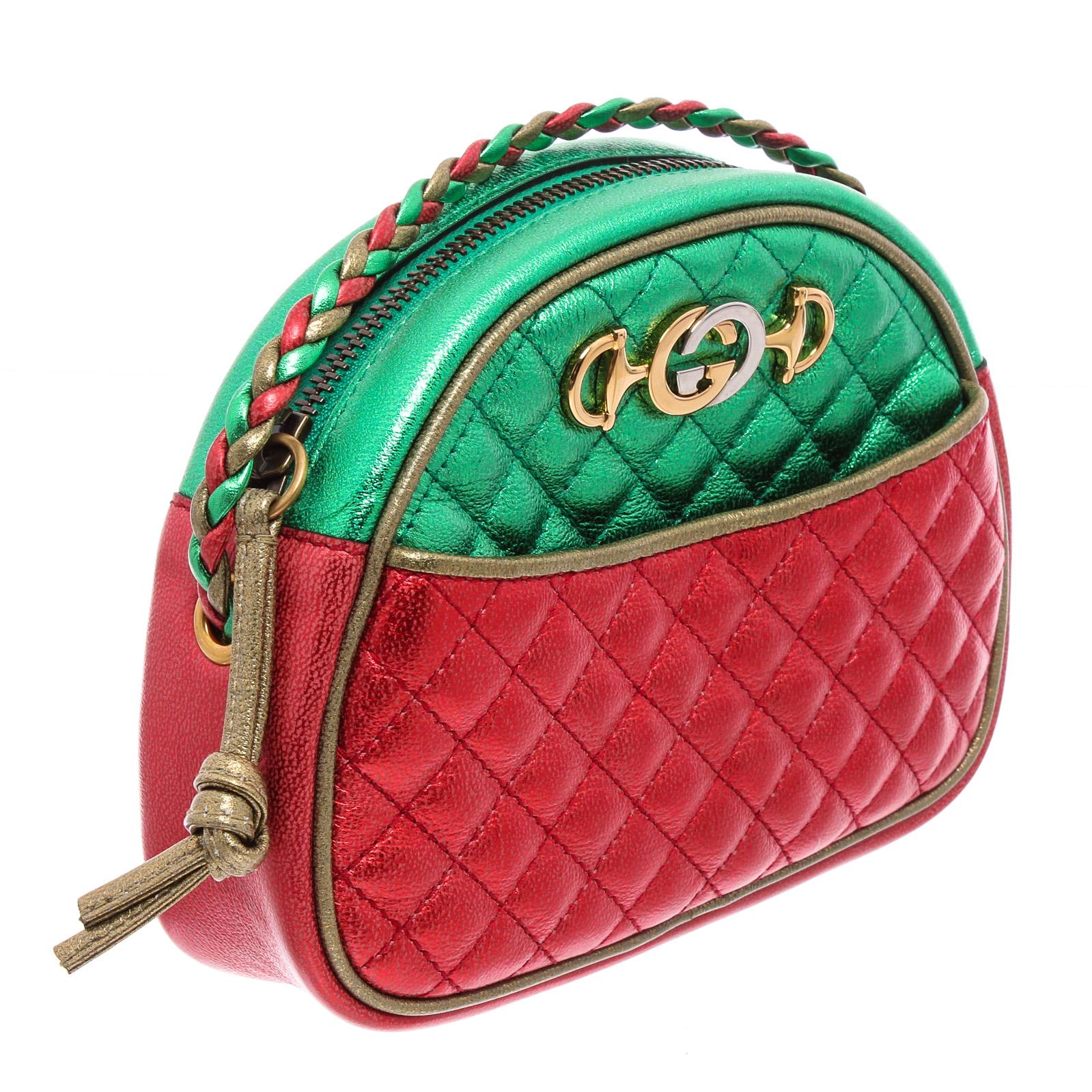 Gucci Mini Trapuntata crossbody bag crafted of textured calfskin leather in a laminated red and green. The shoulder bag features a waist length braided shoulder strap and has combined its horse bit and interlocked G insignias in gold and silver tone