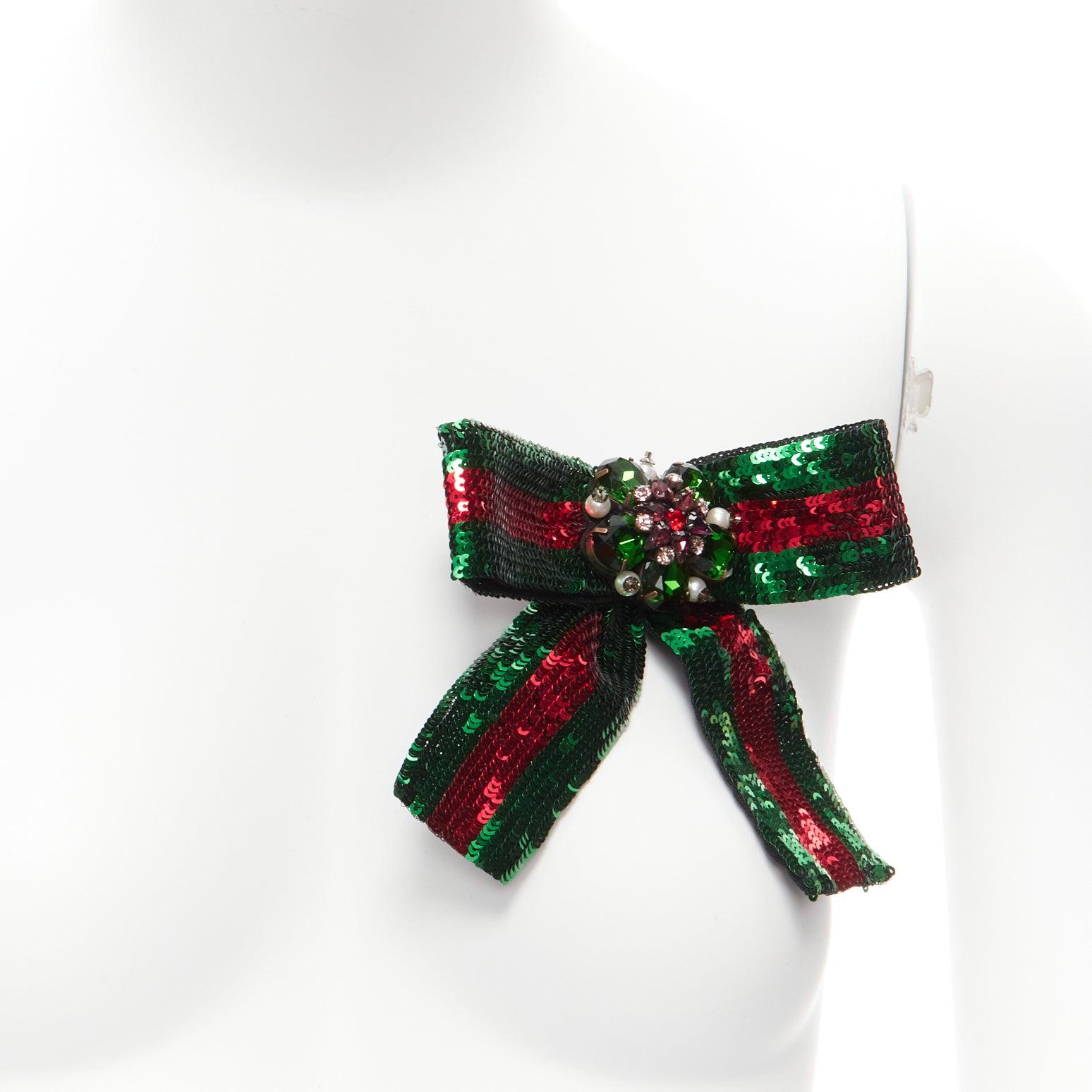 `GUCCI red green signature web sequins crystal bead embellished bow brooch
Reference: TGAS/D00532
Brand: Gucci
Designer: Alessandro Michele
Material: Metal, Fabric
Color: Red, Green
Pattern: Striped
Closure: Pin
Lining: Black