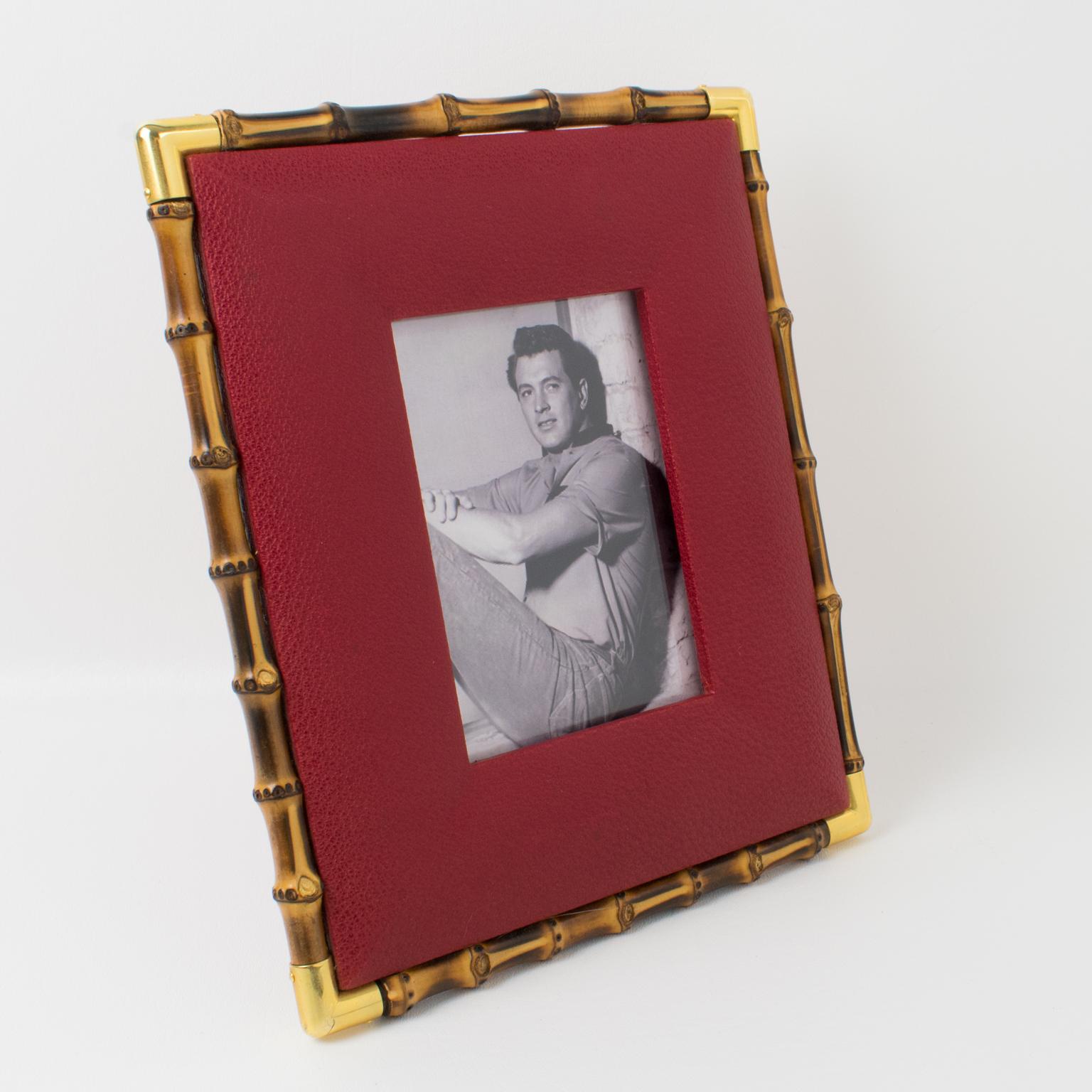 Superb picture photo frame by Italian designer Gucci. Timeless and elegant red calfskin leather with textured pattern ornate with real bamboo and polished brass accents. Back and easel in same red leather with gold leaf hot-stamped Gucci, Made in