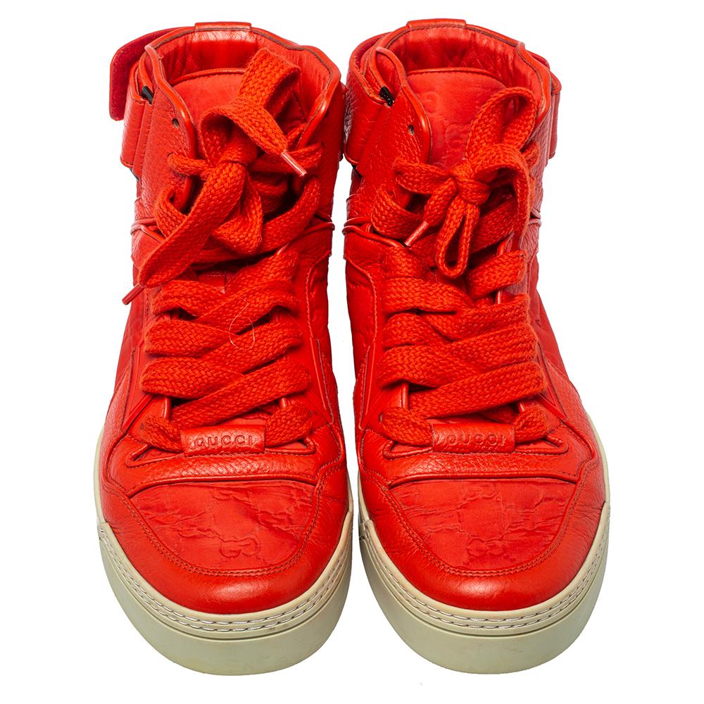 Gucci's high-top sneakers come crafted from leather and nylon and flaunt Guccissima motifs. They feature a red hue, laces on the vamps, and tough rubber soles. These sneakers are perfect to create a stylish casual look.