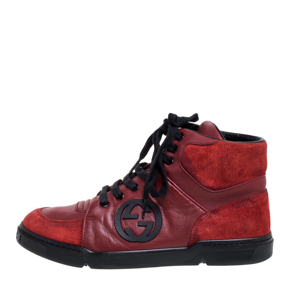 Let your fashion sense speak for you as you wear these trendy Gucci high-top sneakers. Round-toed in design, these sneakers are made from suede and leather and feature the interlocking GG logo appliqués at the sides. They are finished with tough