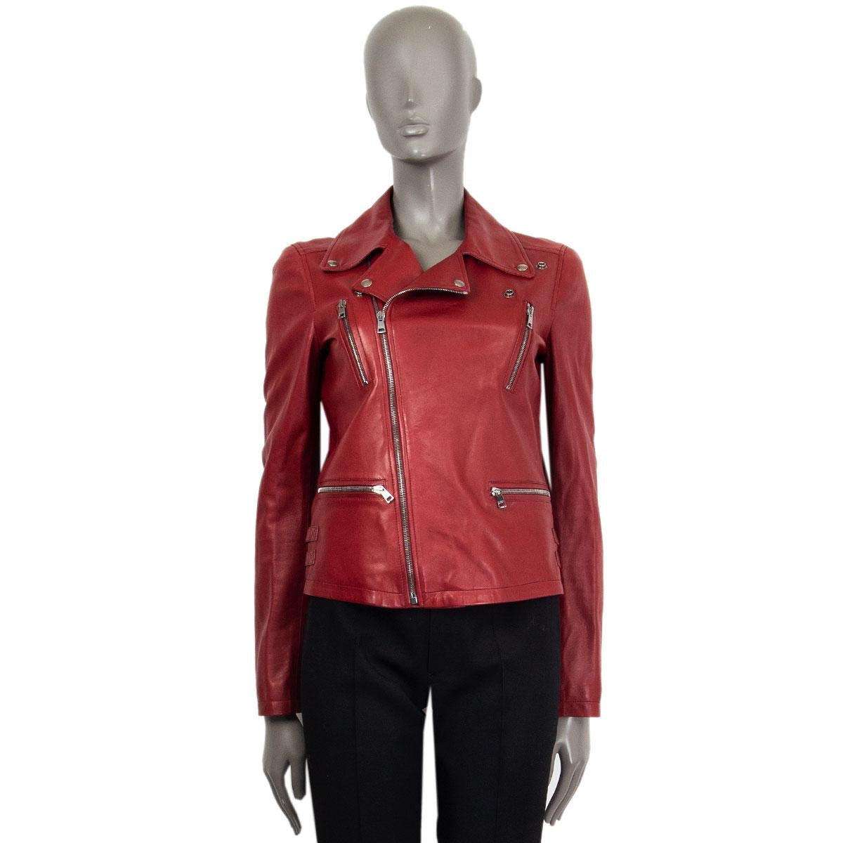 Gucci biker jacket in dark red lamb leather with four front zipper pockets, side decorative belts and zipped cuffs. Closes on the front with a zipper. Lined in cotton (100%). Shows sings of wear around the inner collar and on the front of the jacket