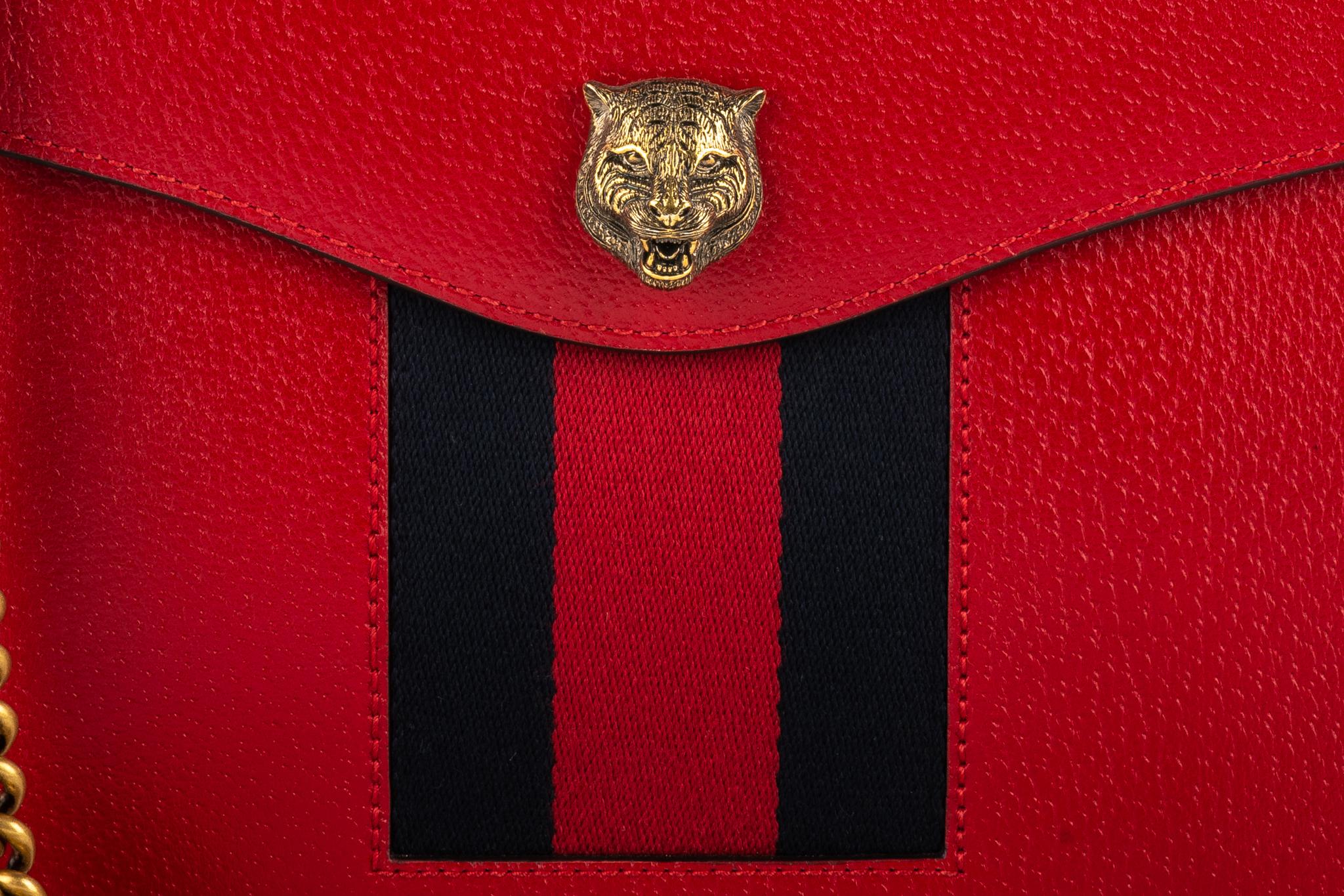 Gucci red durable leather striped cross body bag. Lions head accent. 
Shoulder drop 22.5