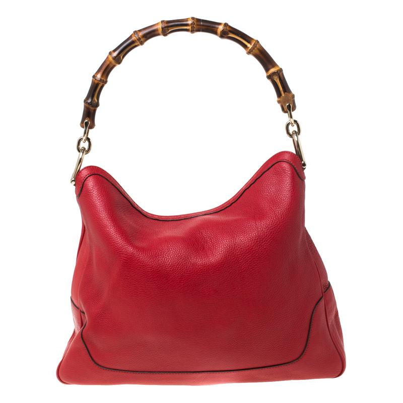 Invest in this timeless creation from the house of Gucci. Sophisticated and elegant, this red tote is made from leather into a slouchy and relaxed shape. This stylish bag comes with a bamboo handle and a detachable shoulder strap for carrying