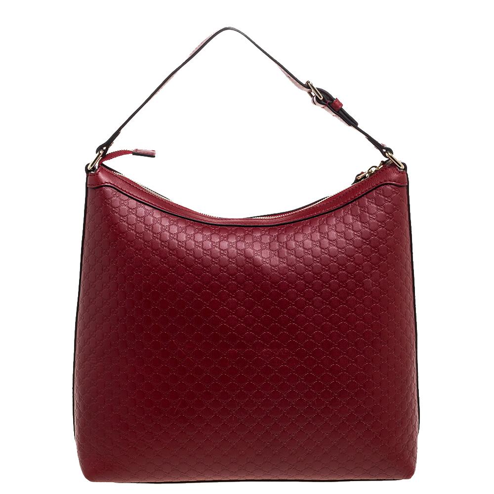 Offering an elegant and understated look for work or otherwise, this Gucci hobo is crafted with red Microguccissima leather. It is held by a single shoulder strap and features a sizeable interior with fabric lining.

Includes: Info Booklet
