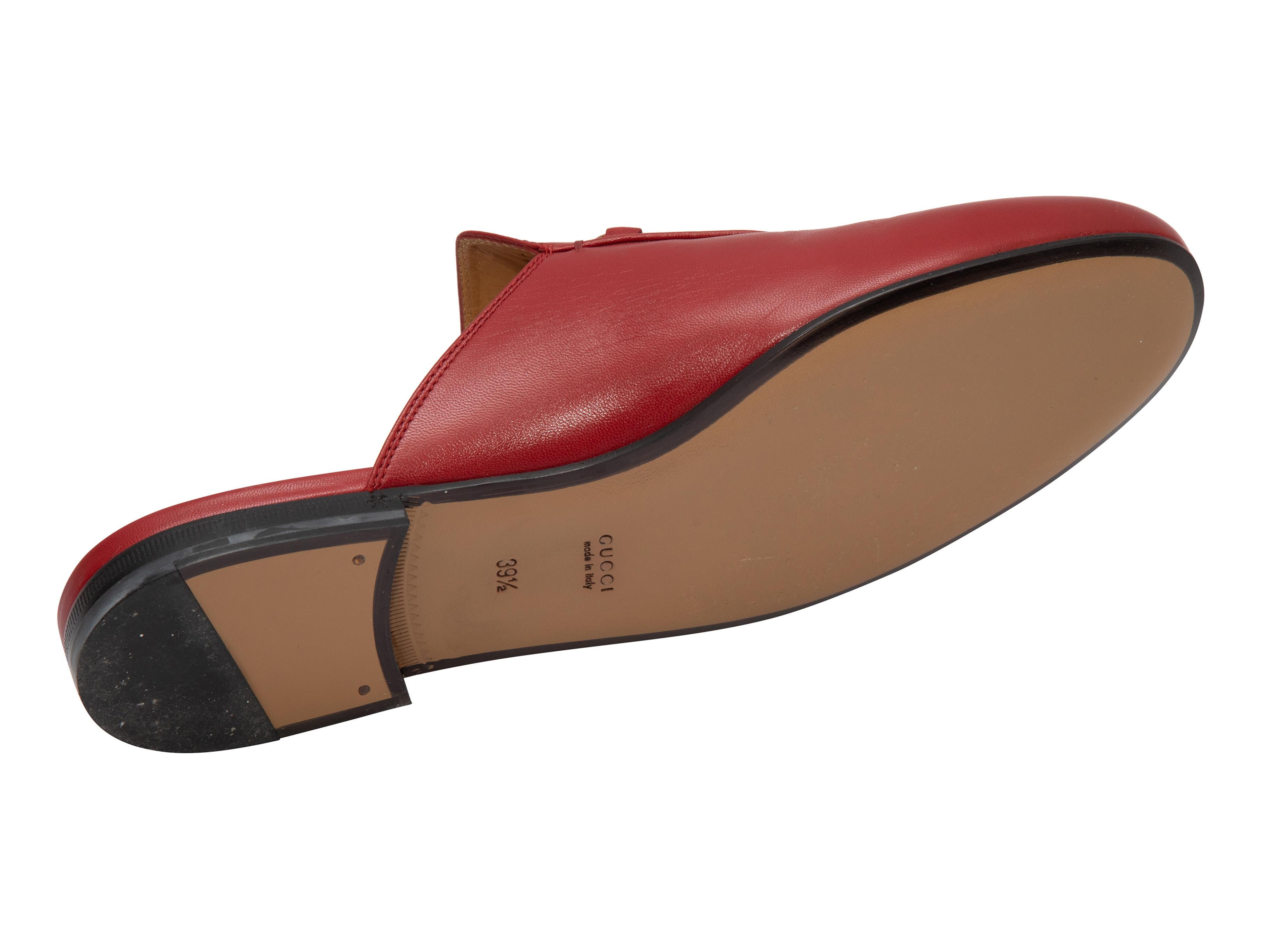 Product Details: Red leather mules by Gucci. Gold-tone Horsebit accents at tops. 1