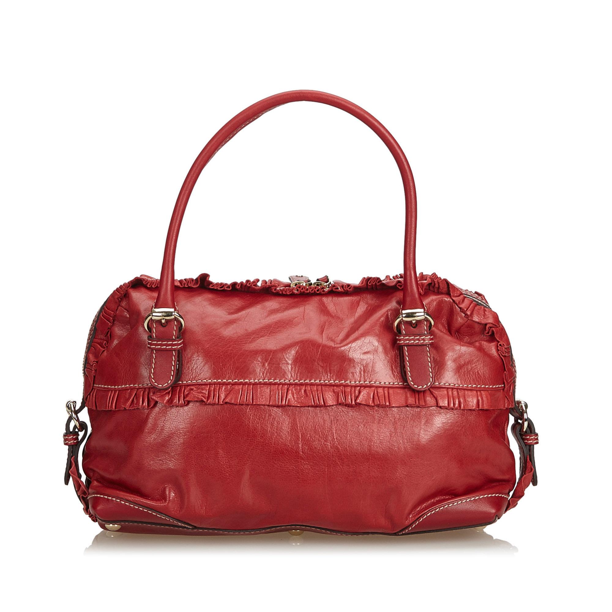 This in-vogue handbag by Gucci will make a classy addition to your outfit. Acquire a sartorial taste of fashion when you step out carrying this red handbag. Make heads turn with this limited edition leather bag.

