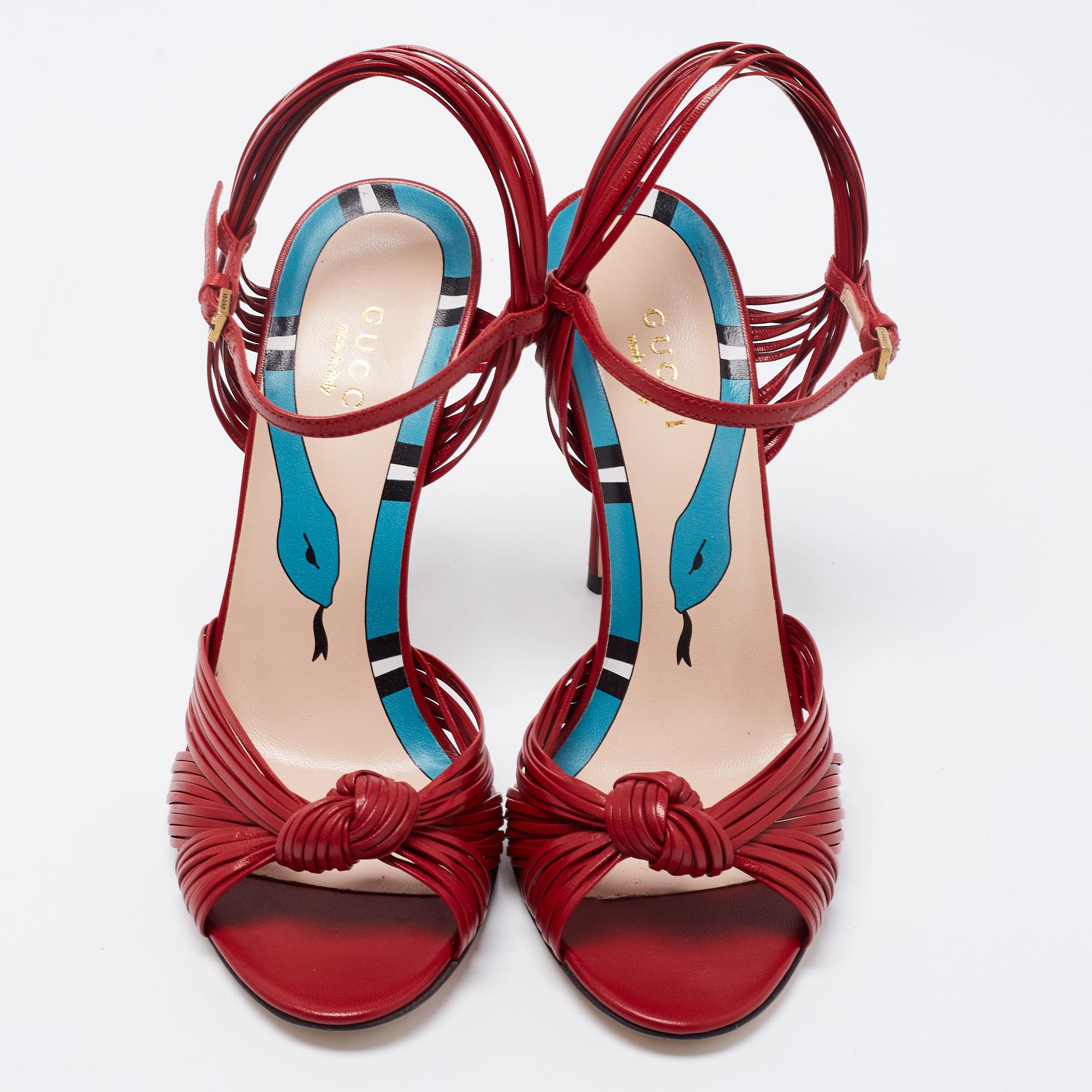 The knotted detailing on the toes serves as a striking element of these Gucci sandals. Created from leather, they are equipped with an ankle buckle closure, grey-tone hardware, and 11cm heels.

