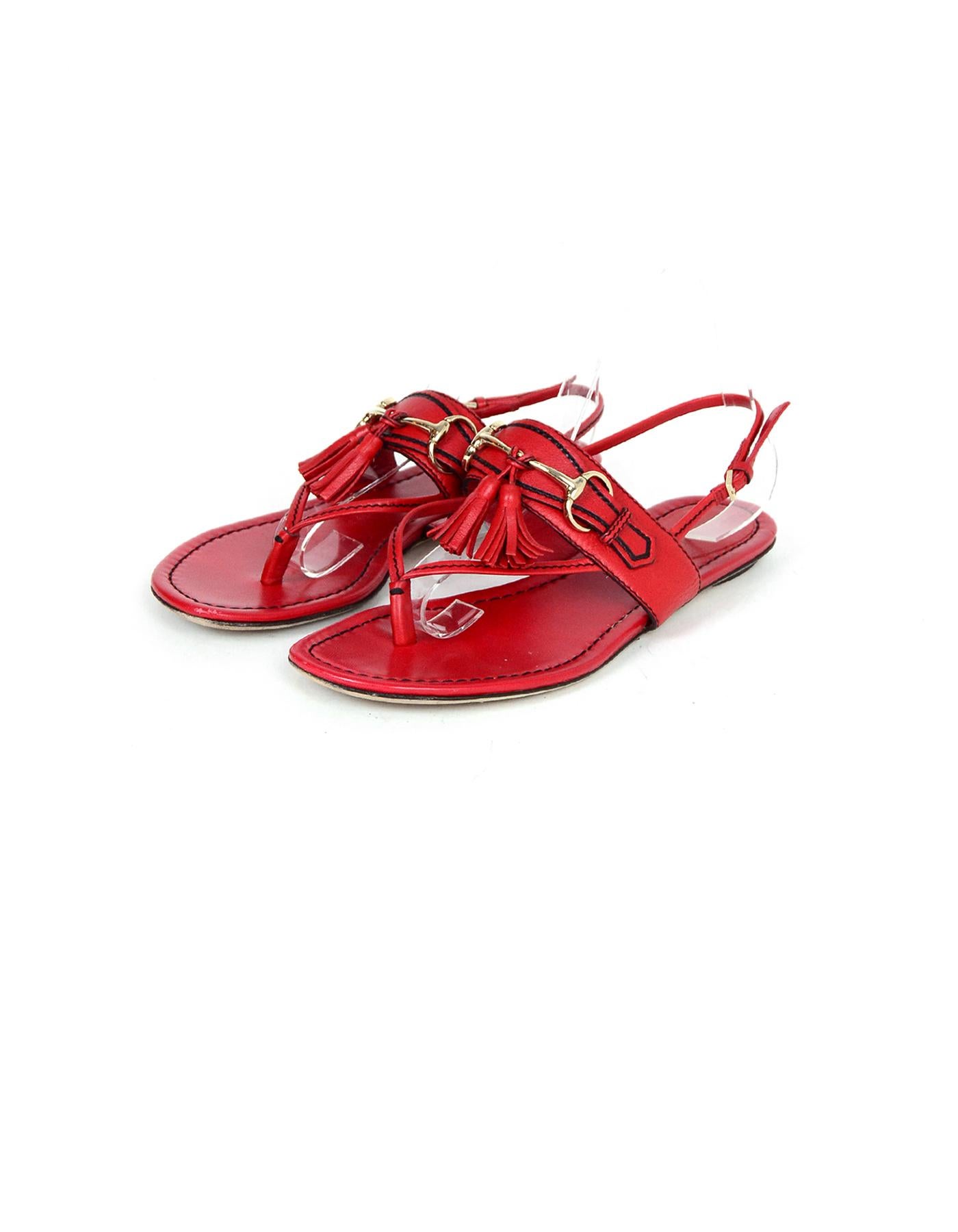 Gucci Red Leather Thong Flat w/ Bit and Tassel sz 38

Made In: Italy
Color: Red
Hardware: Silvertone
Materials: Leather
Closure/Opening: Side buckle
Overall Condition: Very good pre-owned condition, wear on soles and color transfer on insoles.