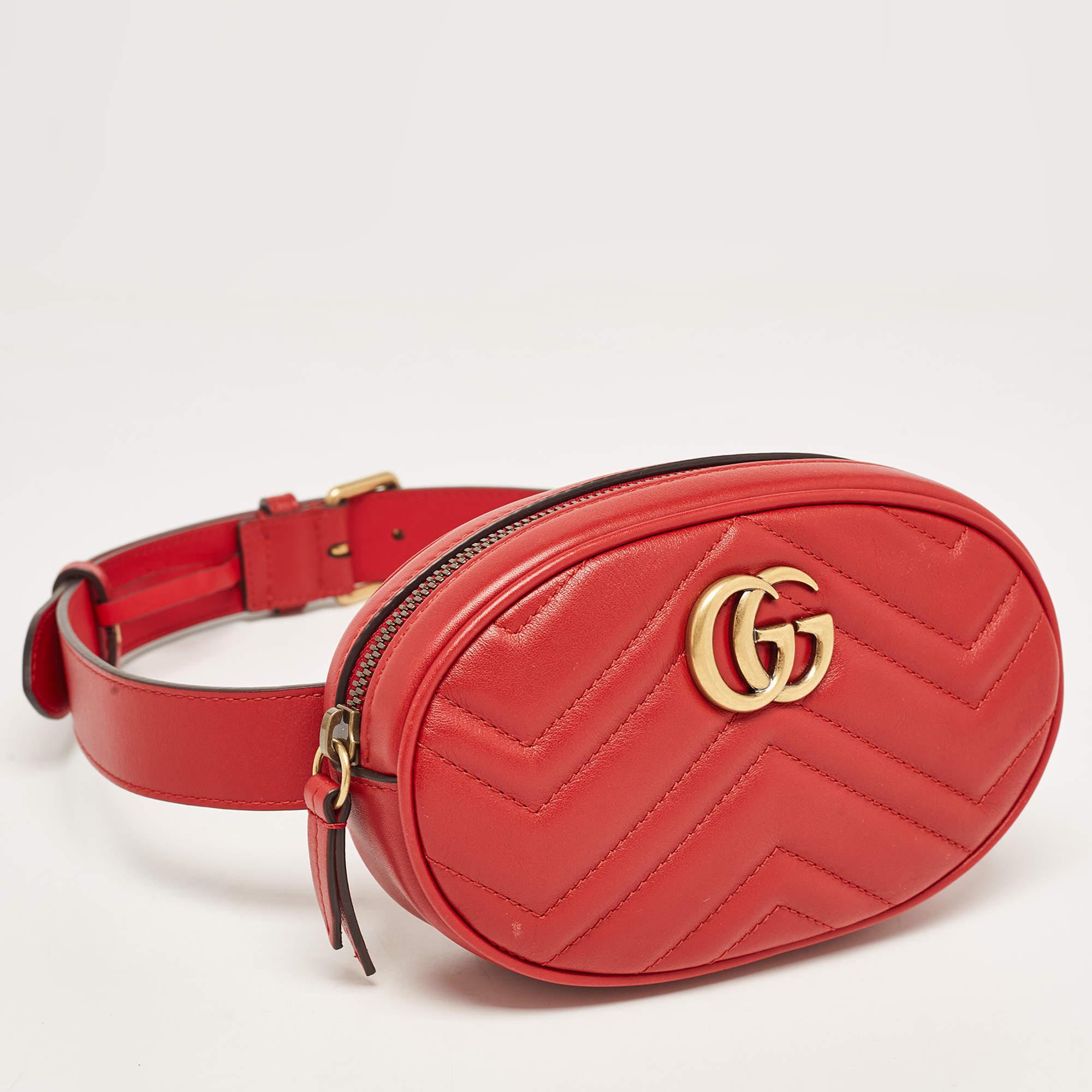 The Gucci belt bag is a luxurious accessory featuring a quilted matelassé pattern, crafted from red leather. The iconic GG logo is elegantly embossed, and the bag can be worn around the waist, offering both style and practicality.

