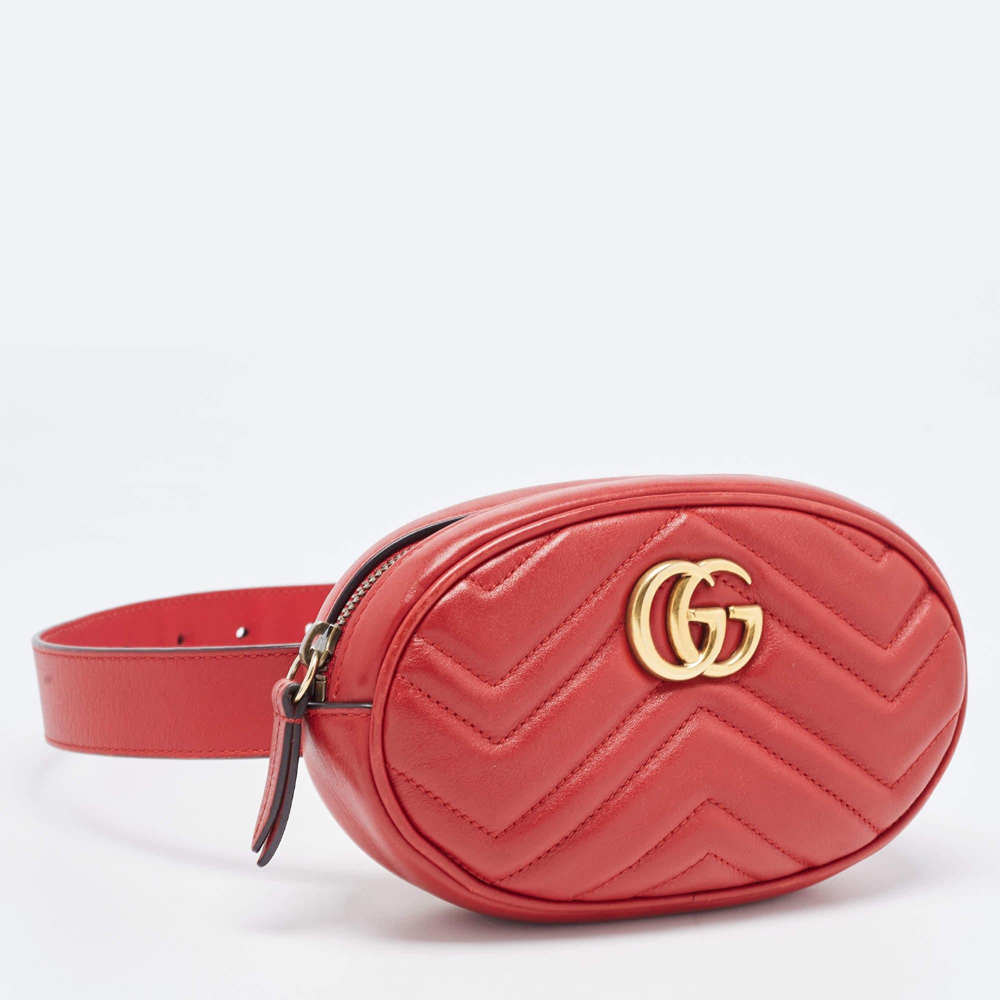 The Gucci GG Marmont belt bag is a stylish and versatile accessory. Crafted from red leather with matelassé stitching, it features the iconic GG logo, a flap closure, and an adjustable belt strap. Perfect for hands-free convenience and adding a