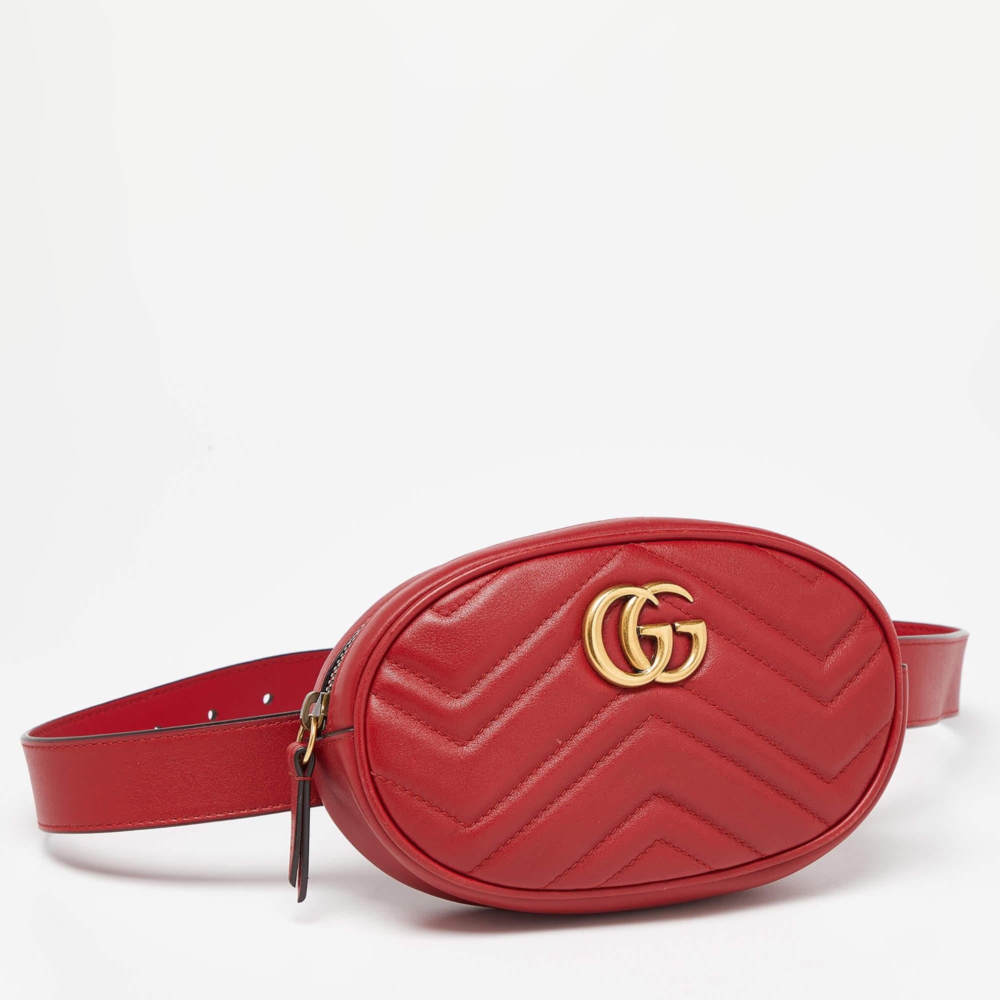 The Gucci GG Marmont belt bag is a stylish and versatile accessory. Crafted from red leather with matelassé stitching, it features the iconic GG logo, a zip closure, and an adjustable belt strap. Perfect for hands-free convenience and adding a touch