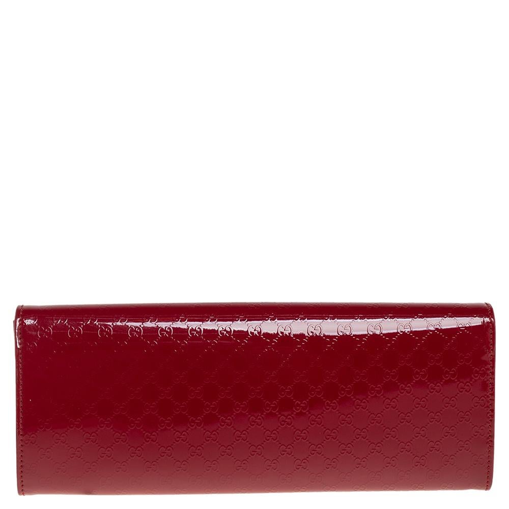 This Gucci clutch is a must-have in your wardrobe to finish your look. This Broadway clutch is crafted from patent leather with micro-Guccissima embossment and features gold-tone hardware. The flap closure with concealed magnetic fastening secures