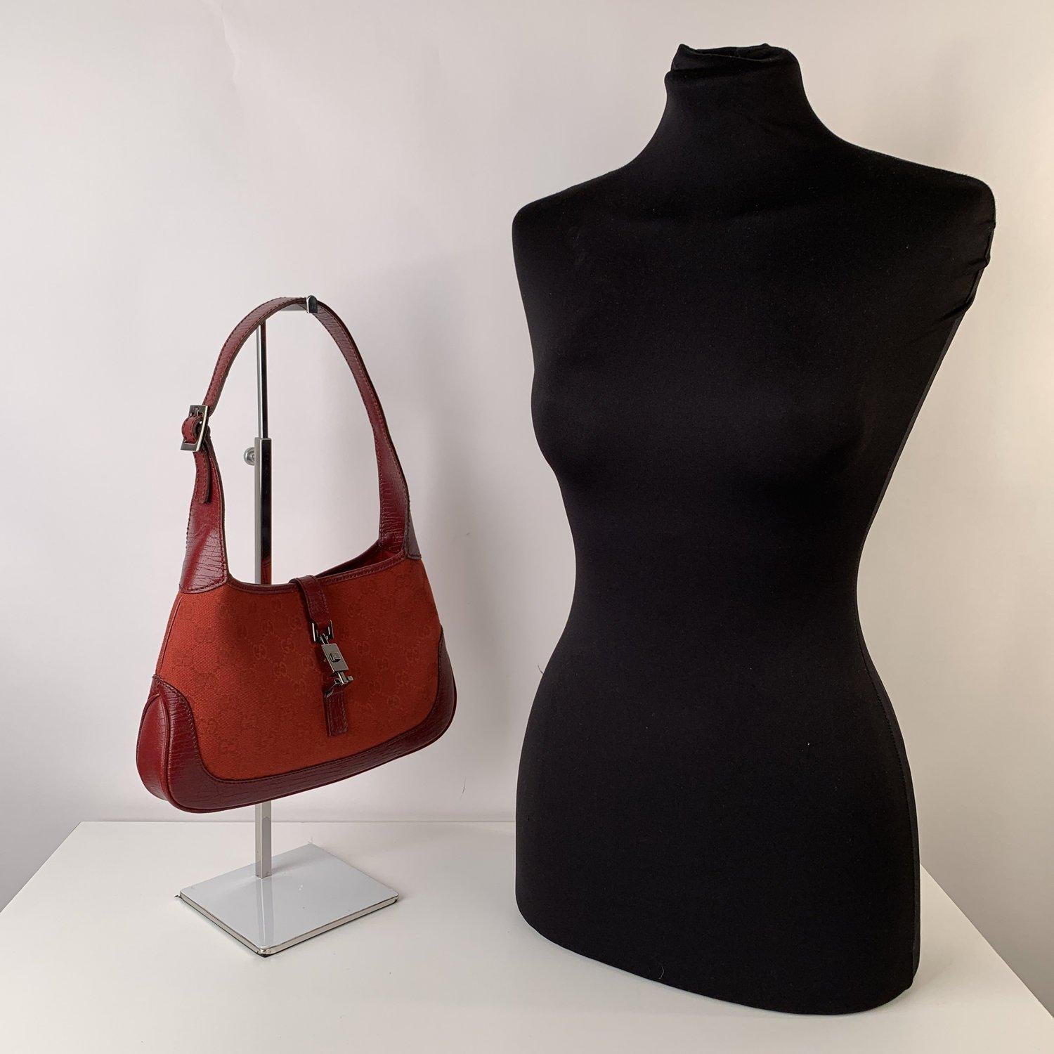 MATERIAL: Canvas, Leather COLOR: Red MODEL: Jackie Bag GENDER: Women SIZE: Small Condition A :EXCELLENT CONDITION - Used once or twice. Looks mint. Imperceptible signs of wear may be present due to storage - Measurements BAG HEIGHT: 7 inches - 17,8