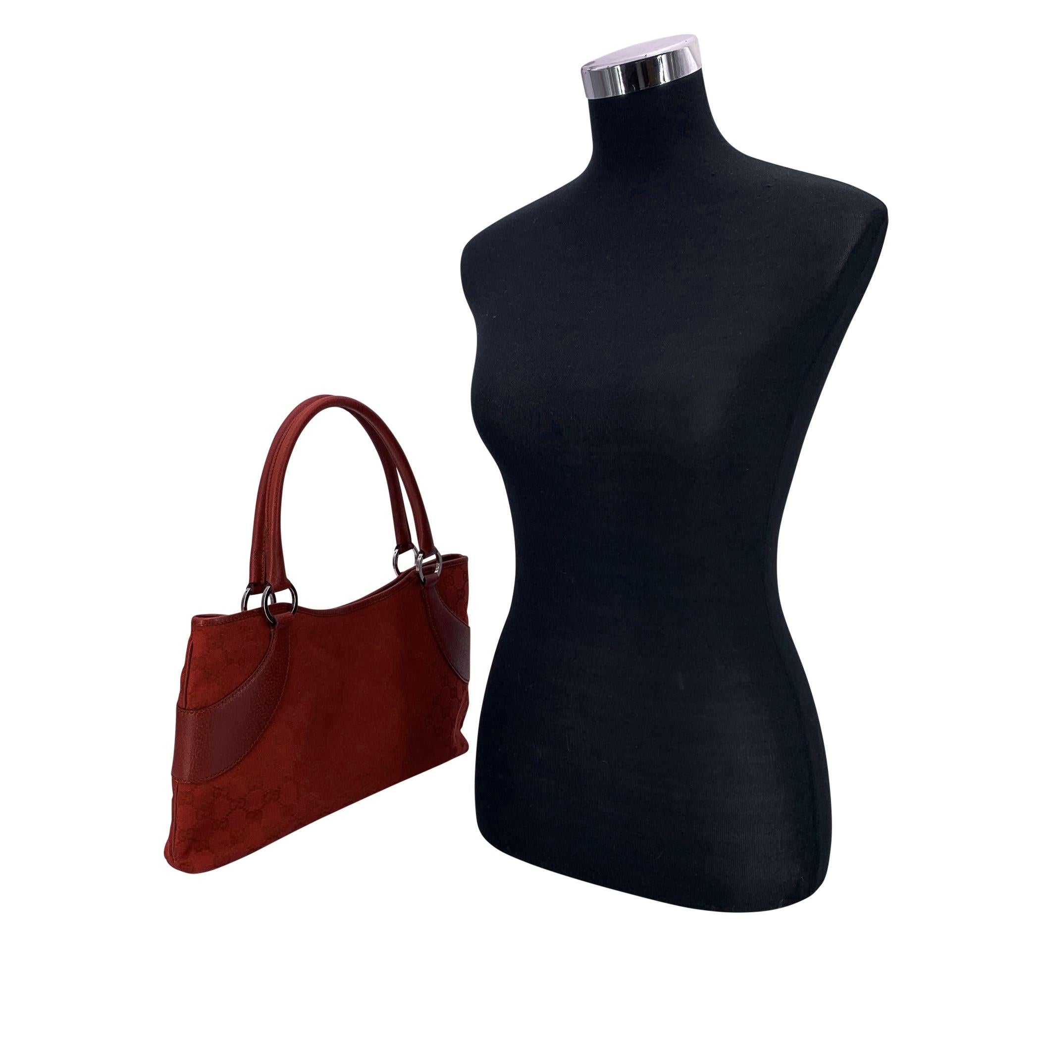 Diese rote Canvas-Tasche mit Monogrammen von Gucci ist eine schöne Anspielung auf mühelosen Luxus und fängt die Essenz der alltäglichen Eleganz mit einer praktischen Note ein. Die Tasche aus rotem Monogram-Denim mit Griffen und Verzierungen aus
