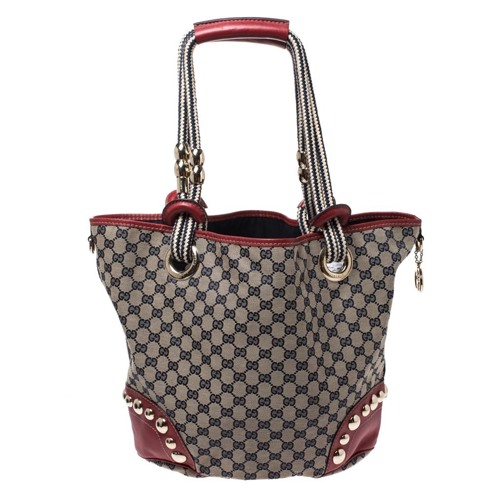 A handbag should not only be good-looking but also functional, just like this pretty Acapulco tote from Gucci. Crafted from the signature GG canvas in Italy, this gorgeous bag comes with red leather trims and lovely knit handles embellished with