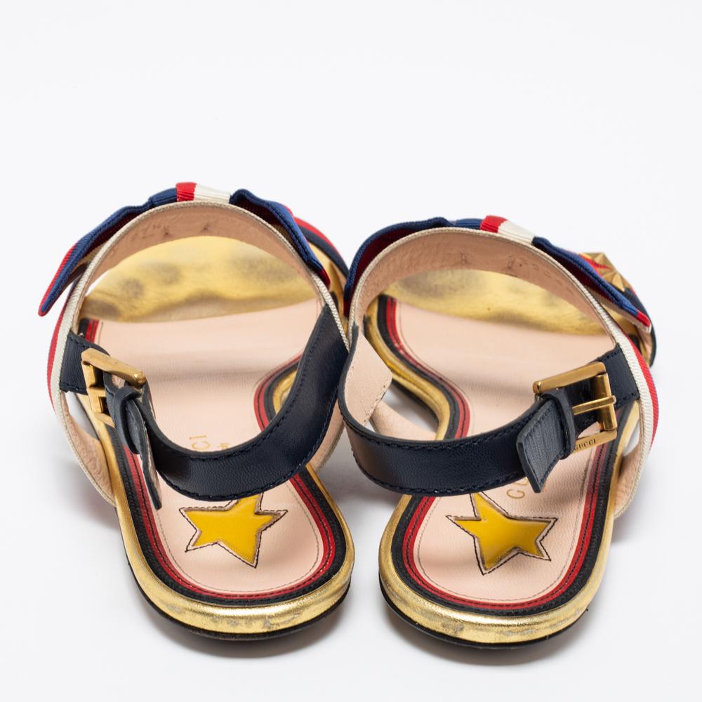 Fill your day with comfortable steps by adorning these Gucci sandals. Crafted from leather and canvas, they display Web stripe detailed straps, bow detailing, and star motifs on the upper. The ankle-buckle closure of this pair will lend you the
