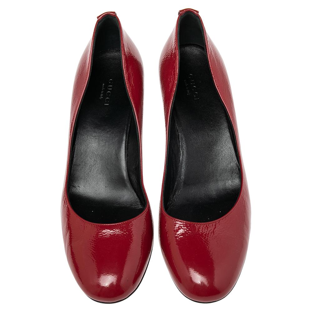 These red pumps from Gucci are simple but a must-have. Crafted using patent leather, and balanced on wedge heels, the round-toe pumps are complete with the logo on the counters. They are high in both style and comfort.

Includes: Original Dustbag