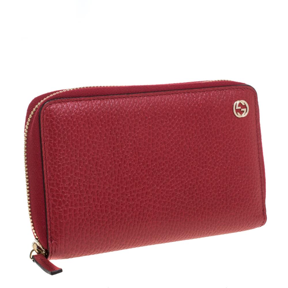 A minimal and sophisticated design, this Gucci wallet is a must-have accessory. Made in Italy from pebbled leather, it flaunts a red shade and the label's accent. Multiple card slots and compartments are secured by a zip-around closure.

Includes: