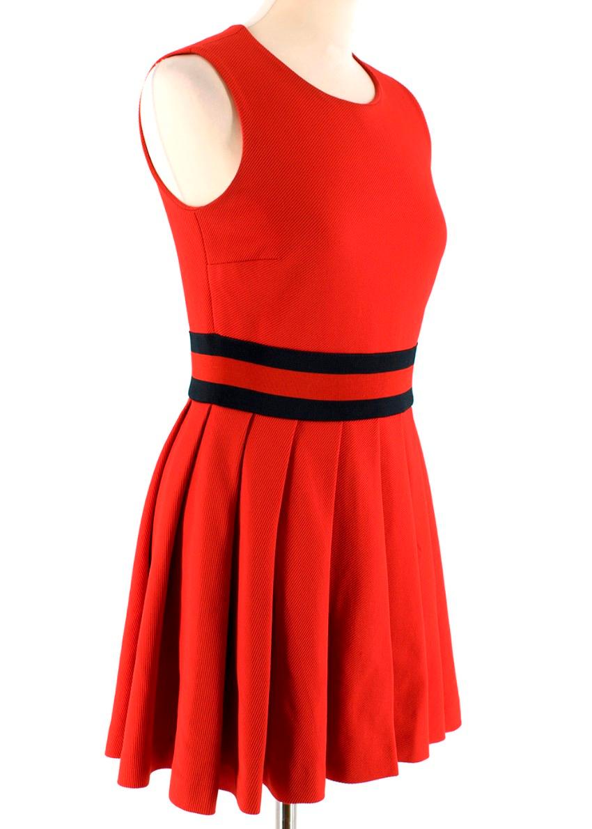 Gucci Red Pleated Gabardine Mini Dress

- Mid/heavyweight
- Red and navy jersey waistband referencing the label's signature 'web' stripe
- Round neck
- Hidden side zip and hook closure
- Pleated flared skirt
- Fitted bodice
-