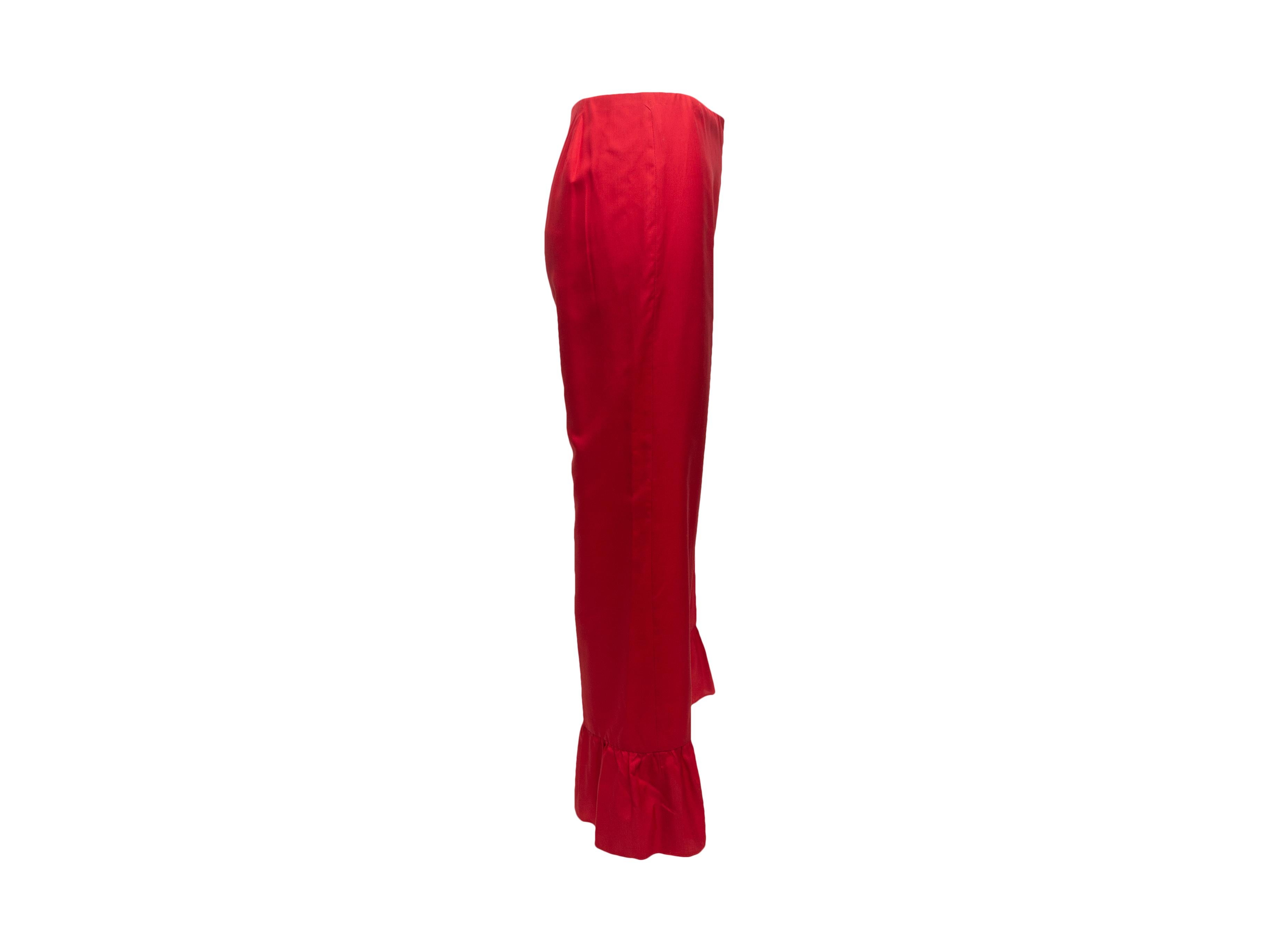 Product details: Red silk pants by Gucci. Ruffle trim at leg openings. Zip at side. 28