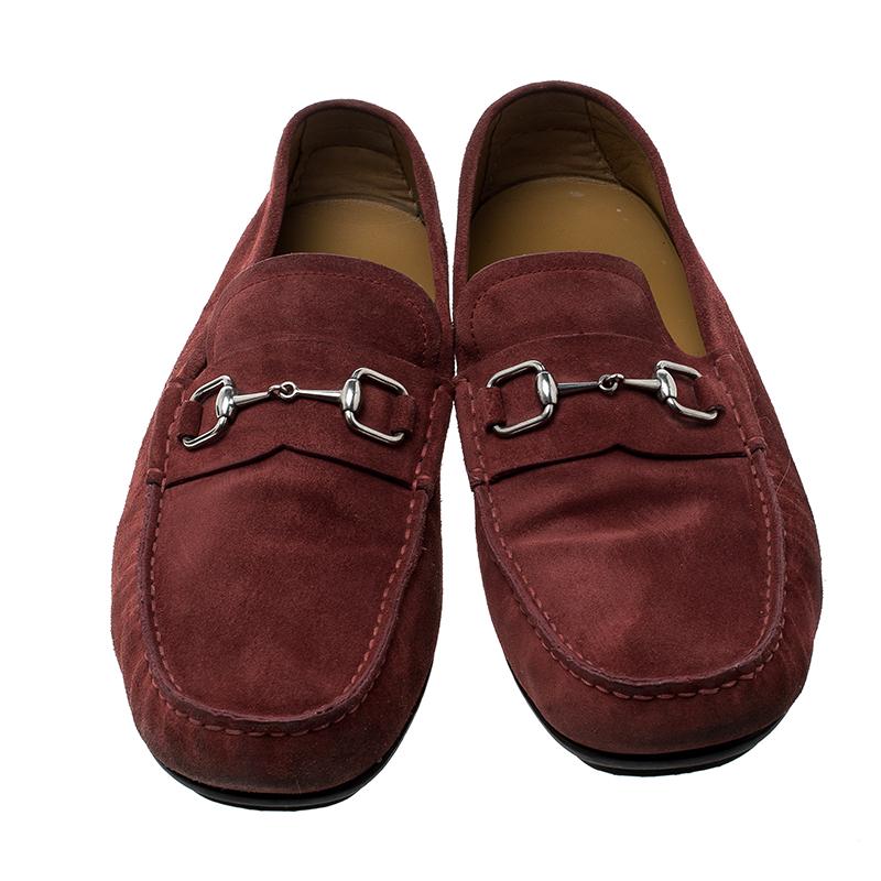 For those informal events and parties, opt for these Gucci loafers to look all dapper and cool. Crafted from a plush red suede body, this pair is detailed with silver-tone hardware at the vamps and features tonal stitch detailing on it. They are set