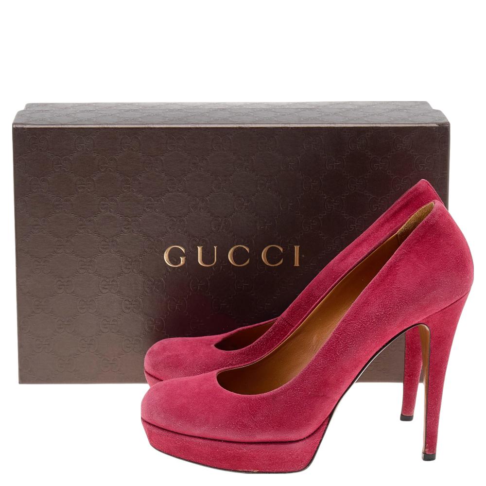 Make a bold style statement with these stunning platform pumps from Gucci. They are crafted from red suede and have a simple yet elegant silhouette. Round-toes, slender 12 cm heels, and leather soles lend the finishing touches to the classic
