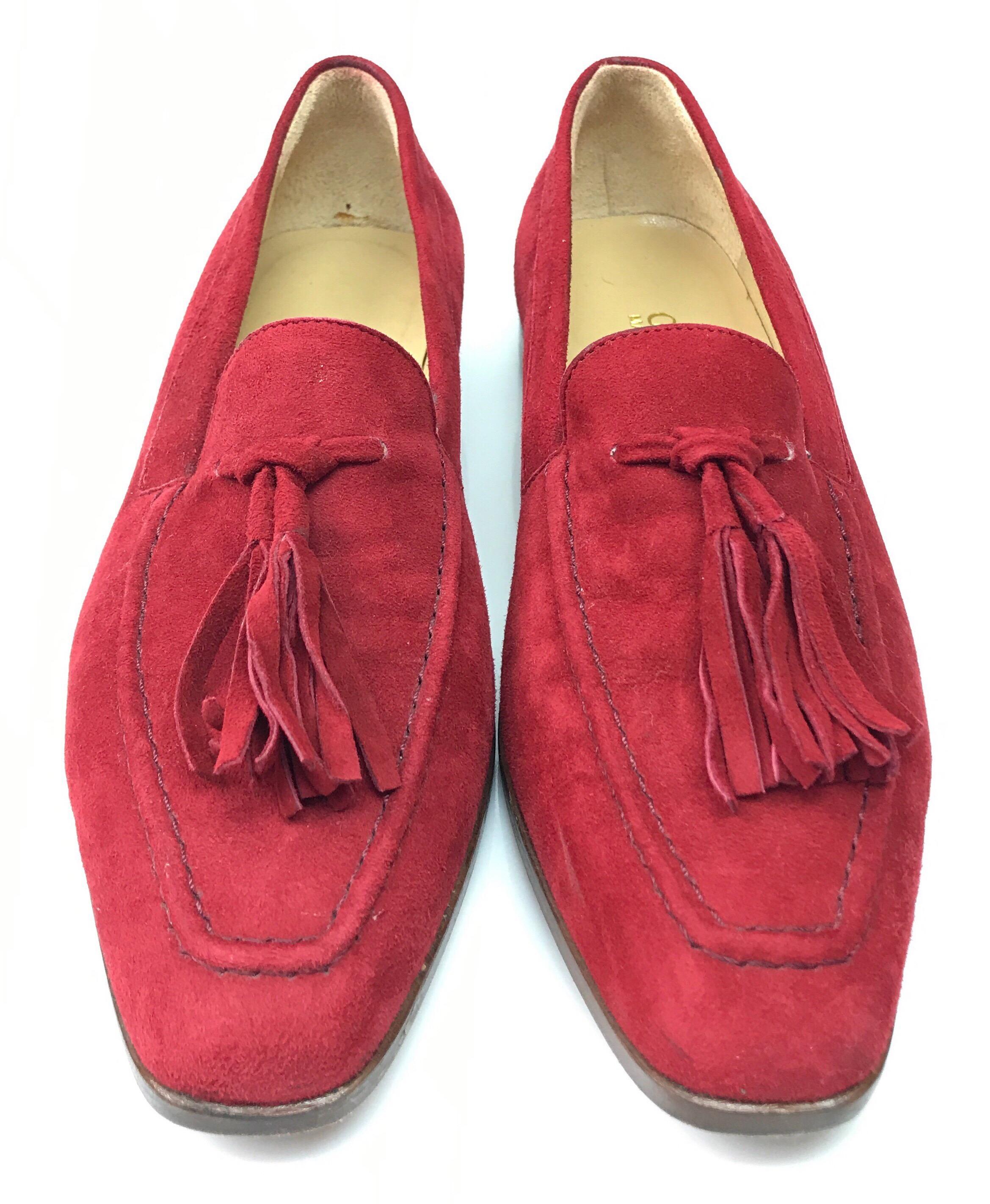 Gucci Red Suede Tassel Loafer - 6. These amazing Gucci loafers are in good condition. They are have some signs of use, including small stains on the inside, and the bottoms being rubbed off. They are made of red suede and have tassels on the front.