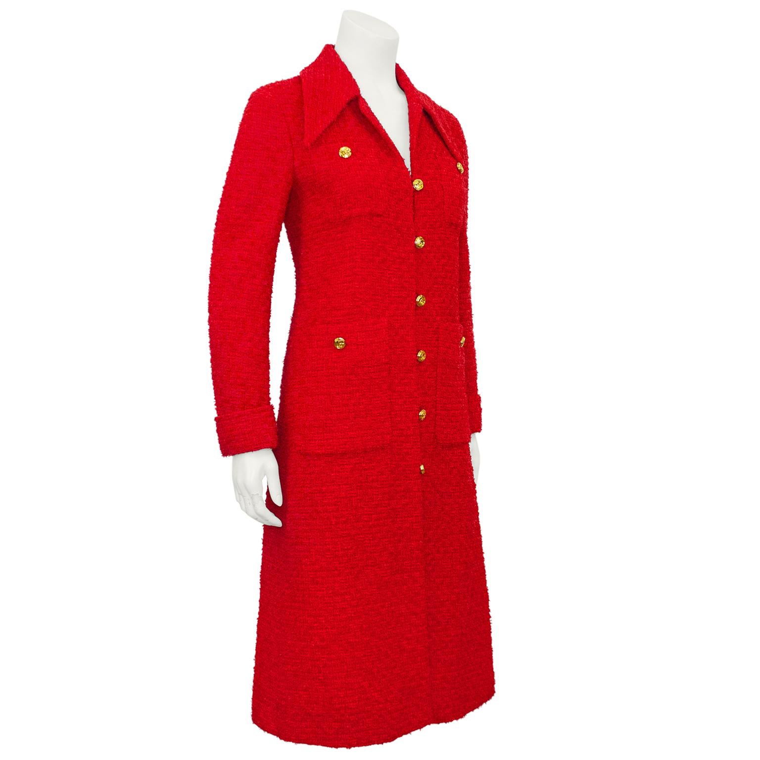 A fabulous long red jacket from Alessandro Michele's for Gucci era, with a nod to classic Chanel. Red bouclé tweed with a large pointed collar, patch pockets at the bust and hips and folded cuffs. Contrasting gold tone metal interlocking GG buttons.