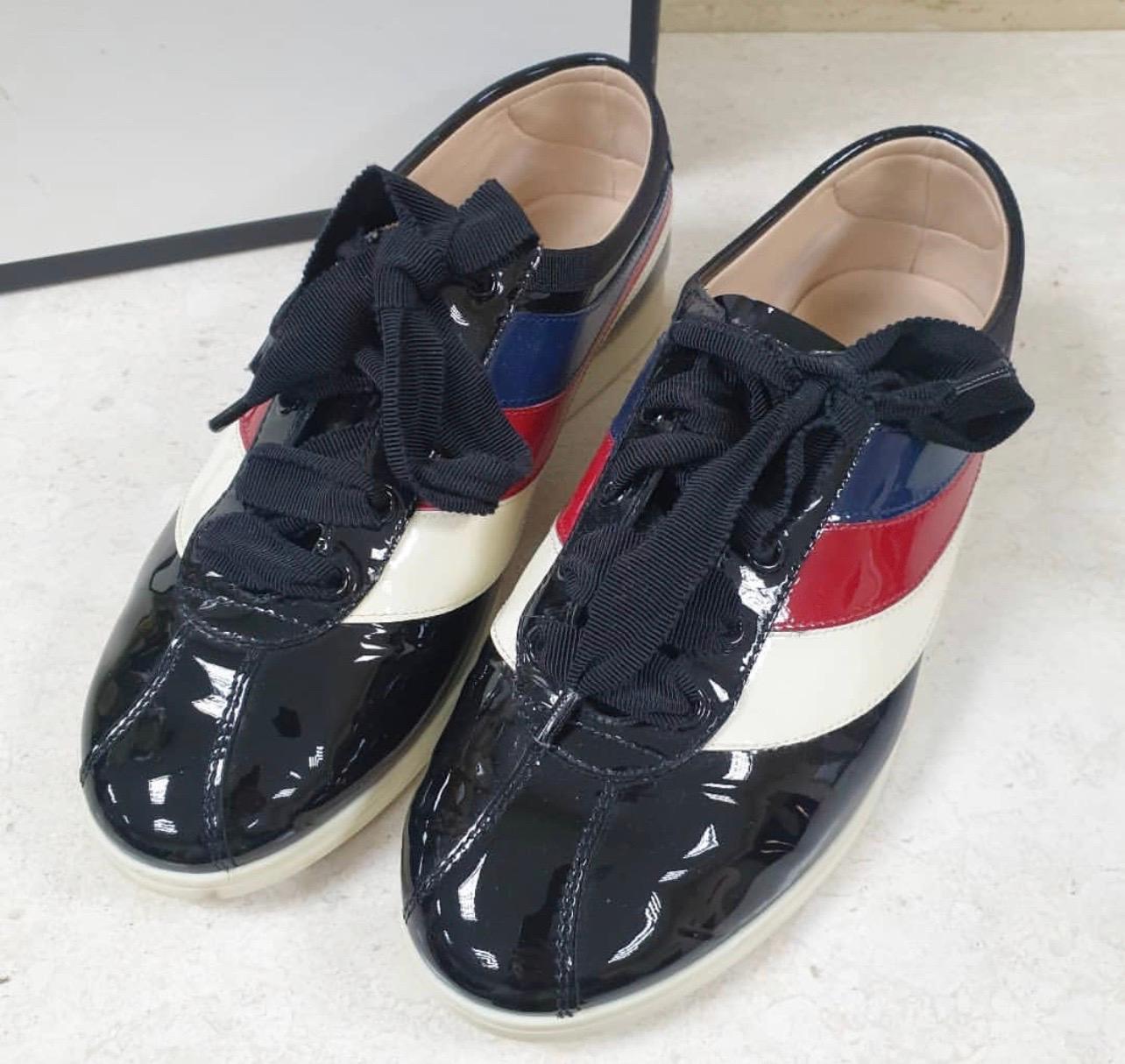 These adorable sneakers are from Gucci. They've been crafted from patent leather and designed as round toes with other details such as lace-ups and butterfly appliques on the uppers. 

The sneakers will offer both comfort and style.

Sz.38

Box is
