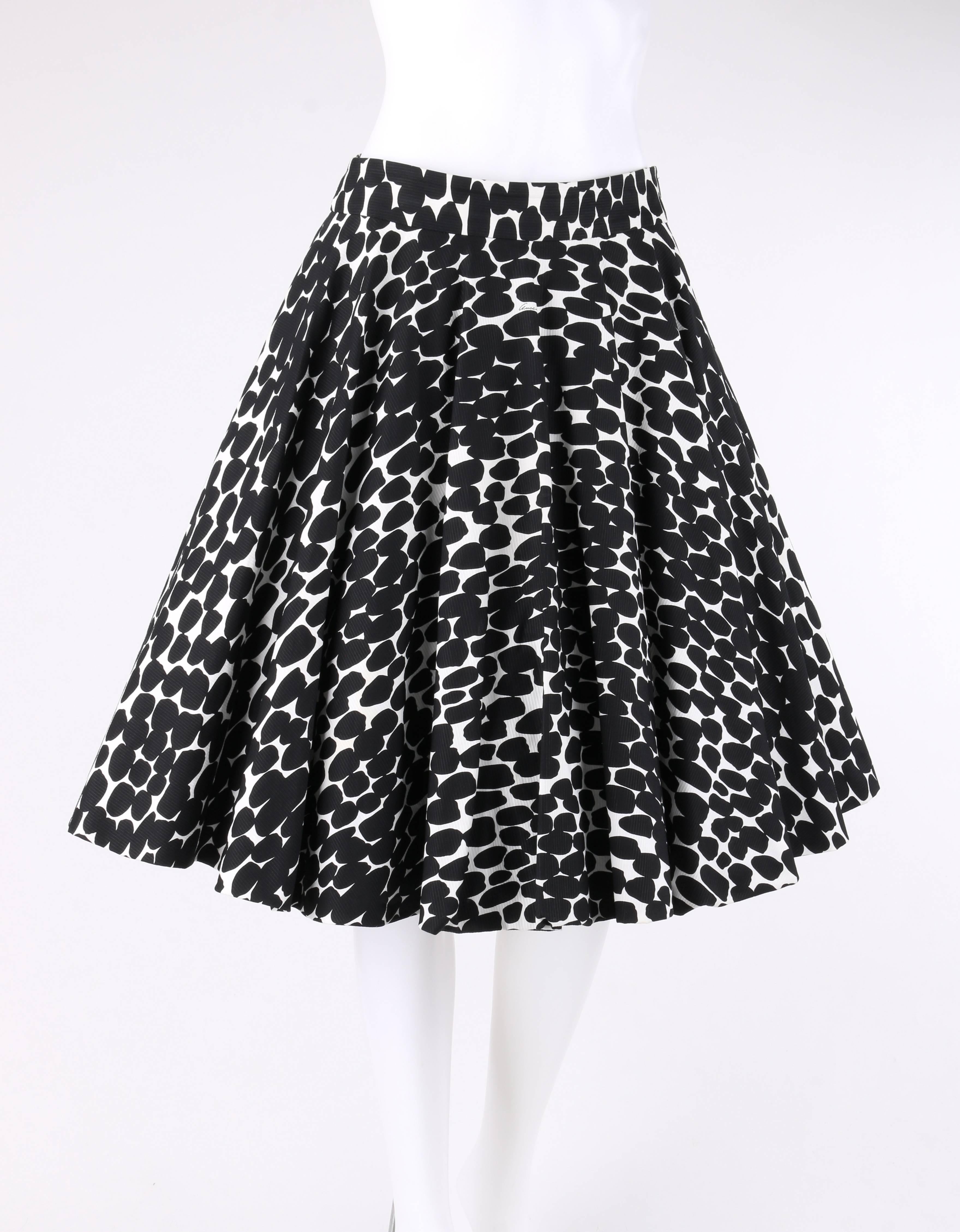 Gucci Resort 2008 black and white abstract polka dot print knee length circle skirt. Runway look #5 designed by Frida Giannini. Black abstract polka dot pattern on white. Full circle skirt style. Banded waistline. Left side seam invisible zipper