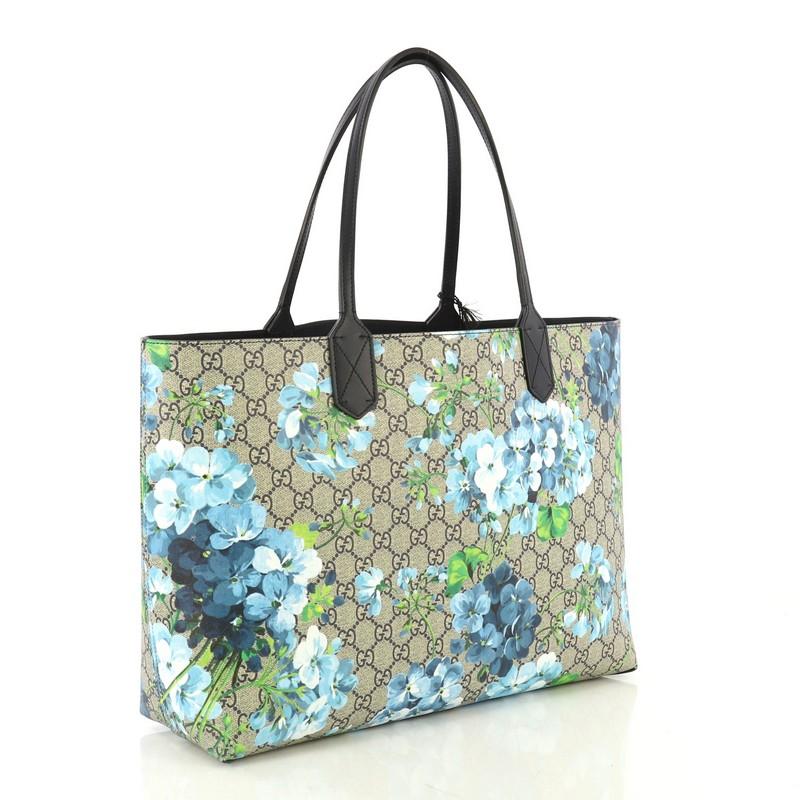This Gucci Reversible Tote Blooms GG Print Leather Medium, crafted from blue blooms GG print leather, features tall slim handles and subtle Gucci logo. Its wide top opens to a reversible navy blue leather interior. 

Estimated Retail Price: