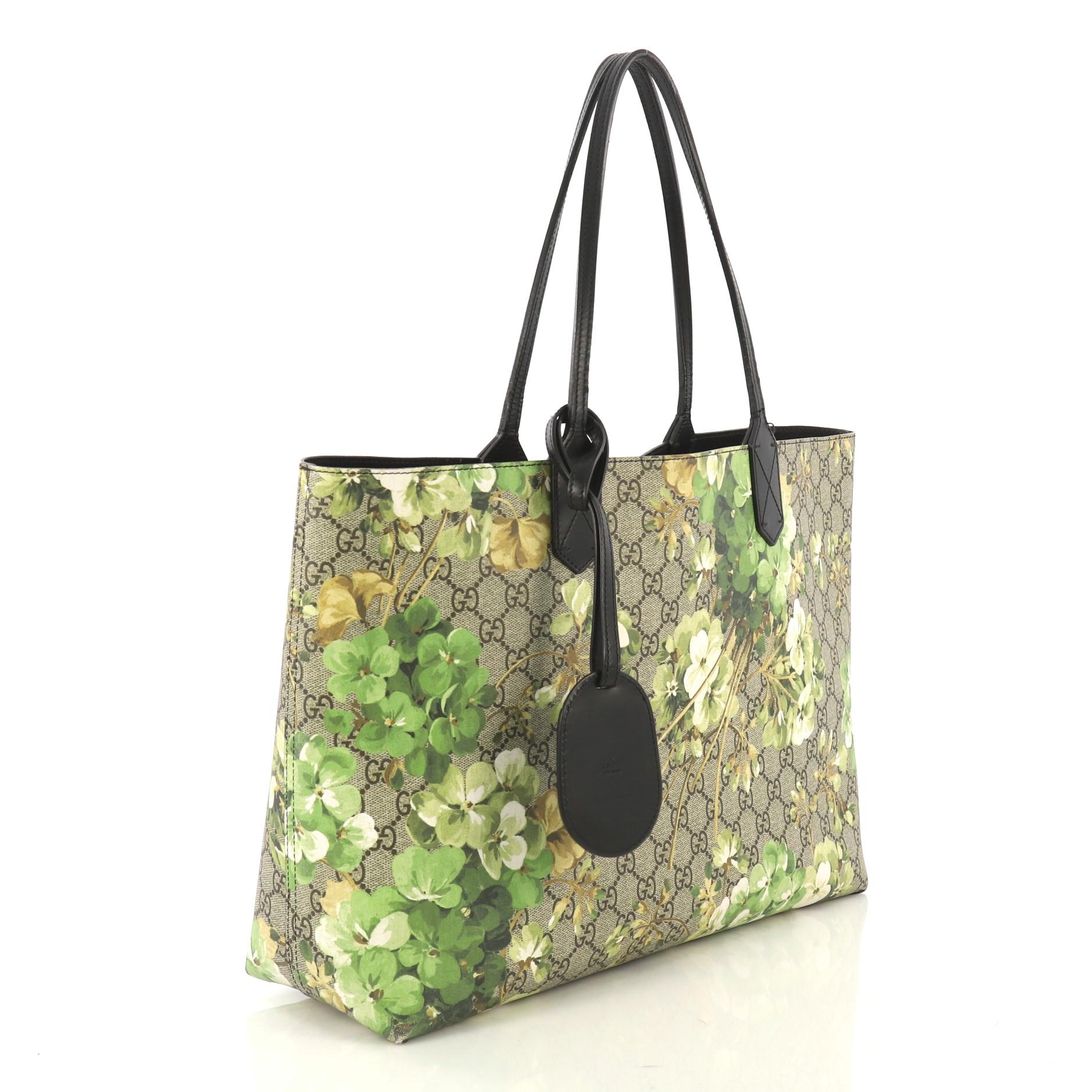 This Gucci Reversible Tote Blooms GG Print Leather Medium, crafted from green blooms GG print leather, features tall slim handles and subtle Gucci logo. Its wide top opens to a reversible black leather interior. 

Estimated Retail Price: