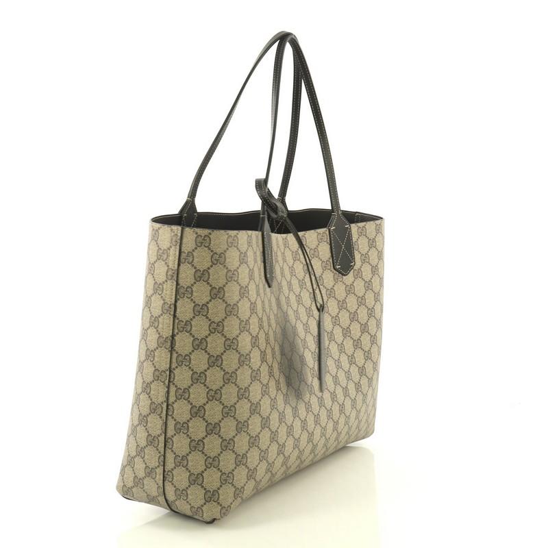 This Gucci Reversible Tote GG Print Leather Medium, crafted in brown GG print leather, features dual flat leather handles. It opens to a reversible black leather interior. 

Estimated Retail Price: $1,250
Condition: Great. Light scuffs on handle