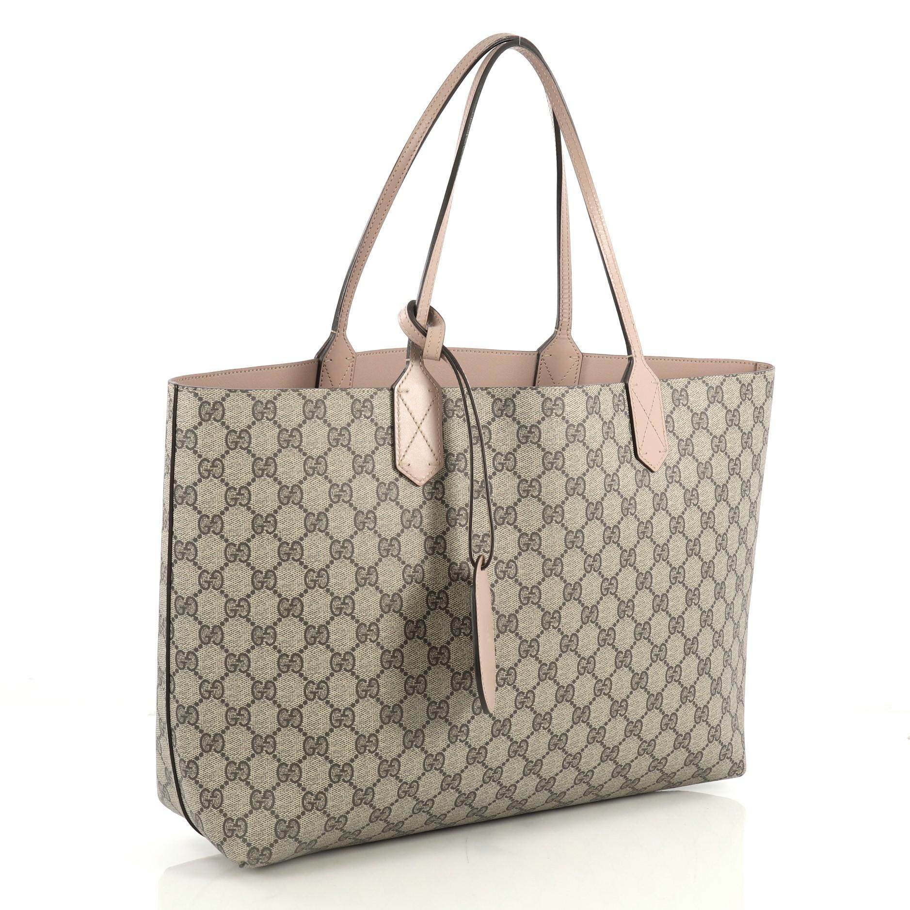 This Gucci Reversible Tote GG Print Leather Medium, crafted in brown GG print leather, features dual flat leather handles. It opens to a reversible neutral leather interior. 

Estimated Retail Price: $1,250
Condition: Great. Wear on base corners,