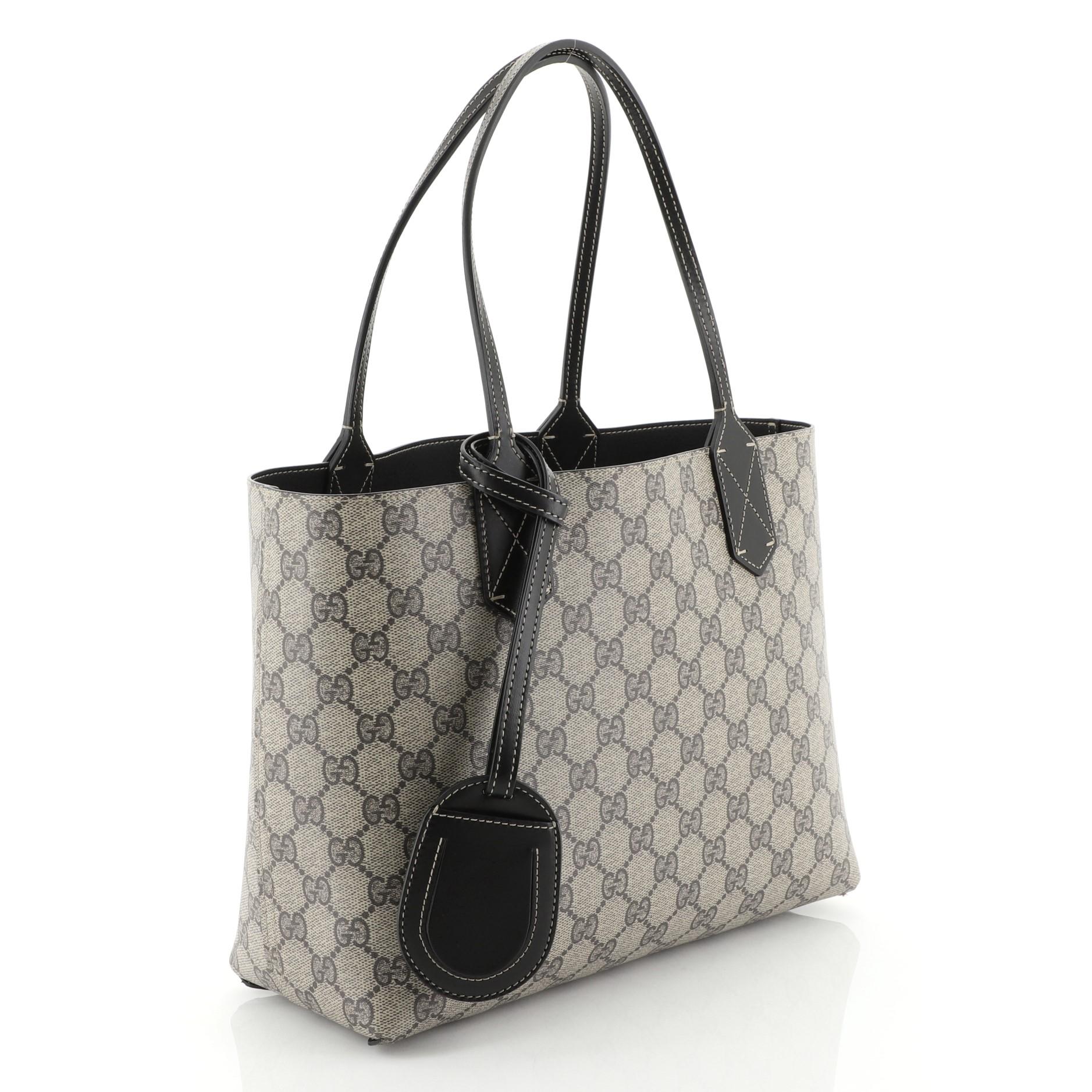This Gucci Reversible Tote GG Print Leather Small, crafted from brown GG print leather, features tall slim handles and subtle Gucci logo. Its wide top opens to a reversible black leather interior. 

Estimated Retail Price: $950
Condition: Excellent.