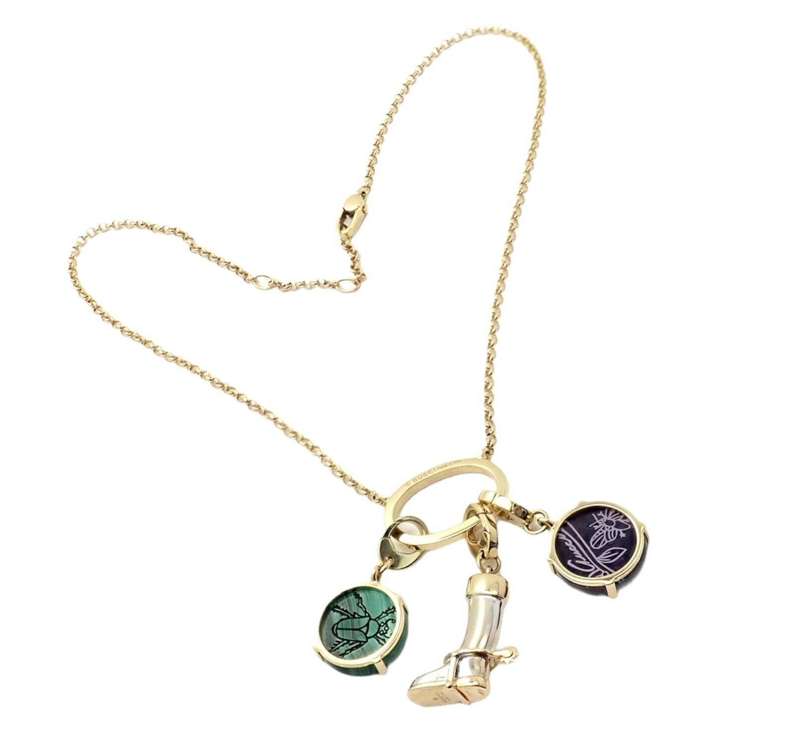 18k yellow and white gold riding boot beetle multi charm pendant necklace from Gucci.
With Green Malachite: 15mm x 3mm
Purple Amethyst: 15mm x 3mm
Measurements: Necklace Chain Length: 16