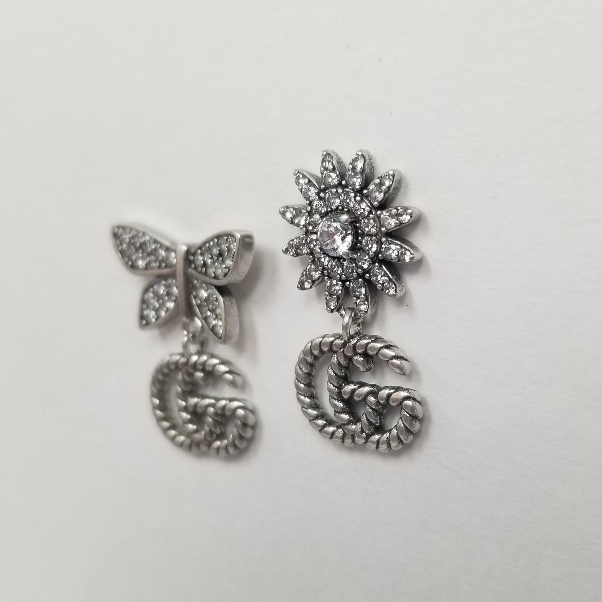 These Gucci earrings from the Flora collection are a mismatch made in heaven! Crafted in Metal Gold Plated with dazzling crystals, the top of one of the earrings resembles a flower, while the other sports a crystal butterfly. A 