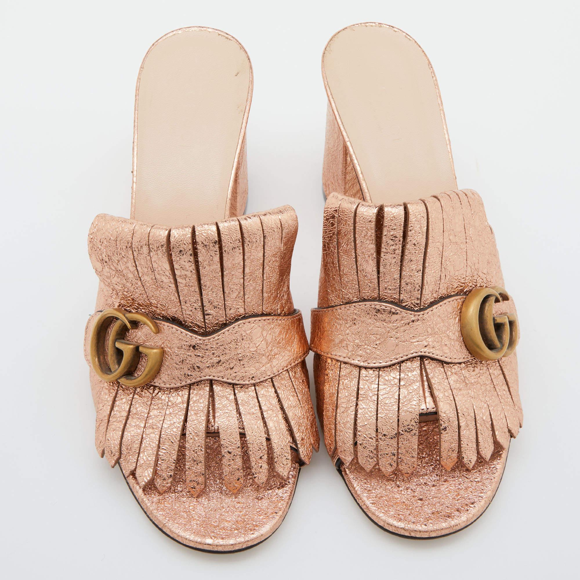 This pair of pumps by Gucci is a buy to wear and treasure. They've been crafted from rose-gold silver foil leather and styled with folded fringes and the brand's signature GG logo on the uppers. Square toes and a set of block heels complete the