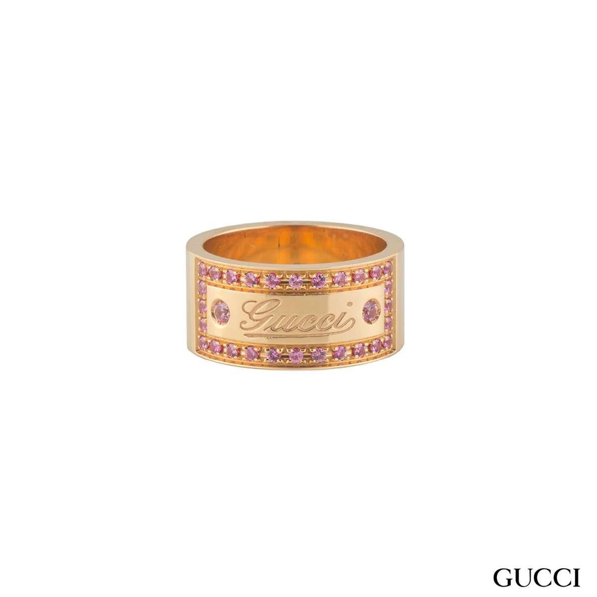 A beautiful 18k rose gold spinel Gucci ring. The ring comprises of a 9mm flat court band with the 'Gucci' logo embossed in the centre. The logo has a box around set with pink spinel gemstones with a weight of approximately 0.49ct, with a pink hue